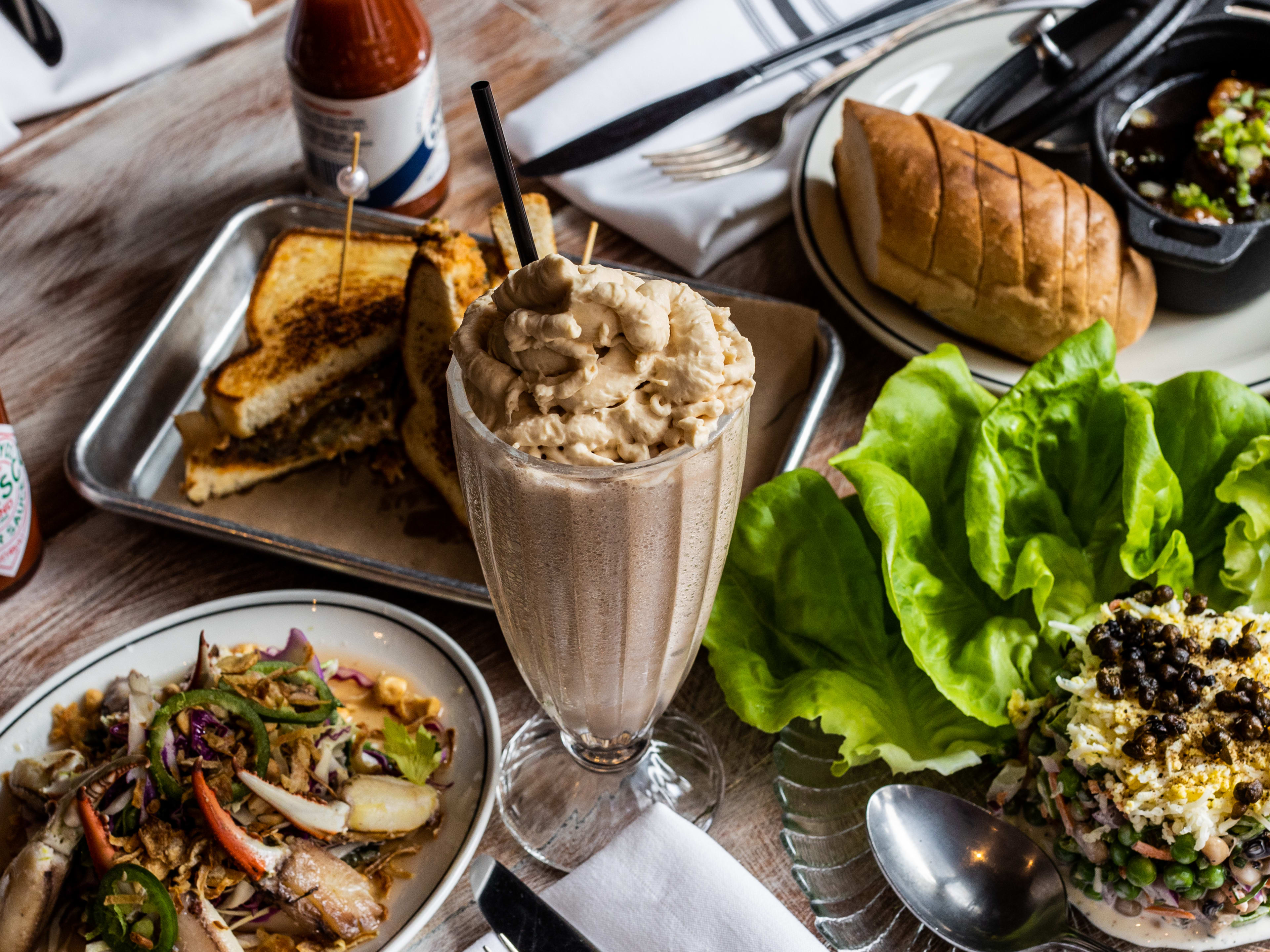 chocolate milkshake, smashed boudin melt, pea salad, and crab fingers