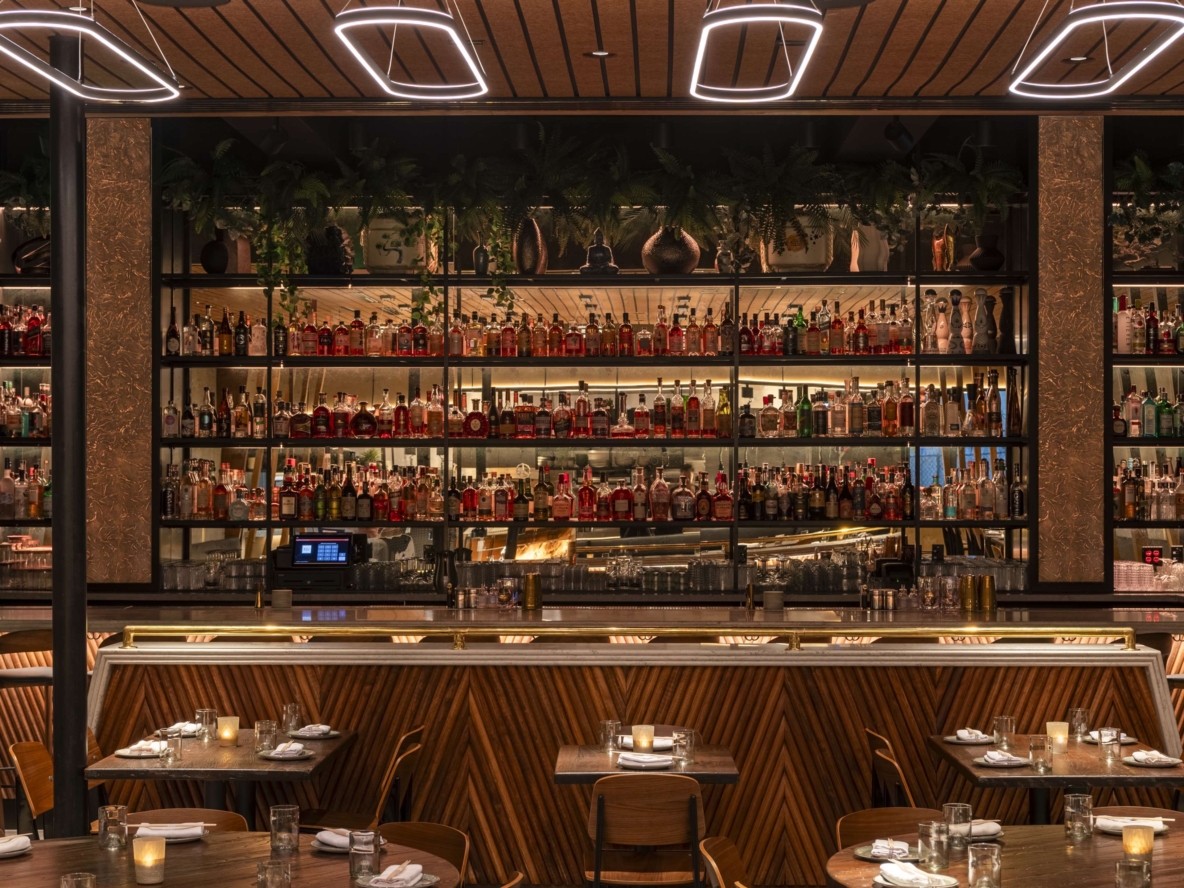 Restaurant interior with bar seating and alcohol shelves