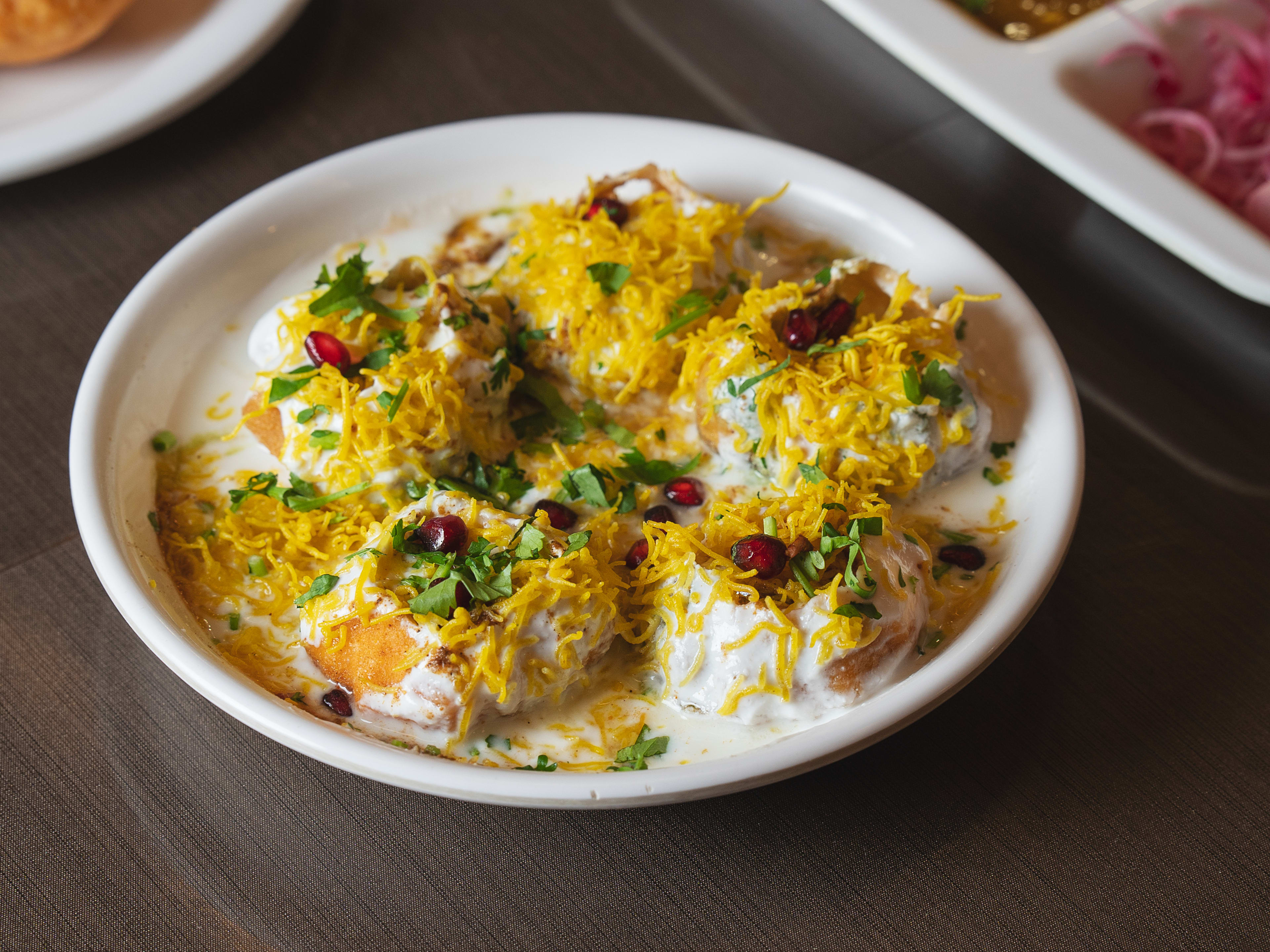 Dahi Puri topped with coconut shavings and pomegranate seeds at Kailash Parbat