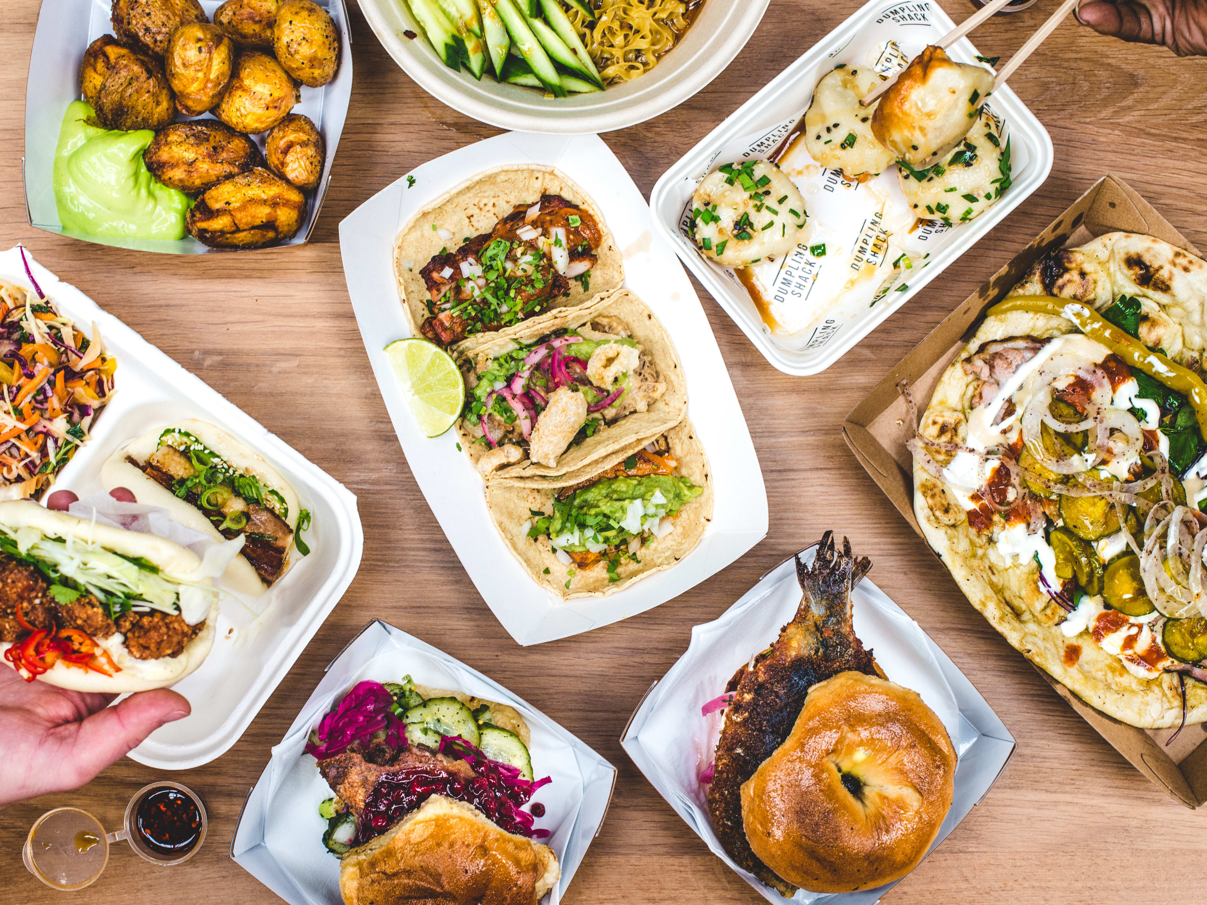 A spread of dishes from different stalls at The Kitchens At Old Spitalfields Market.