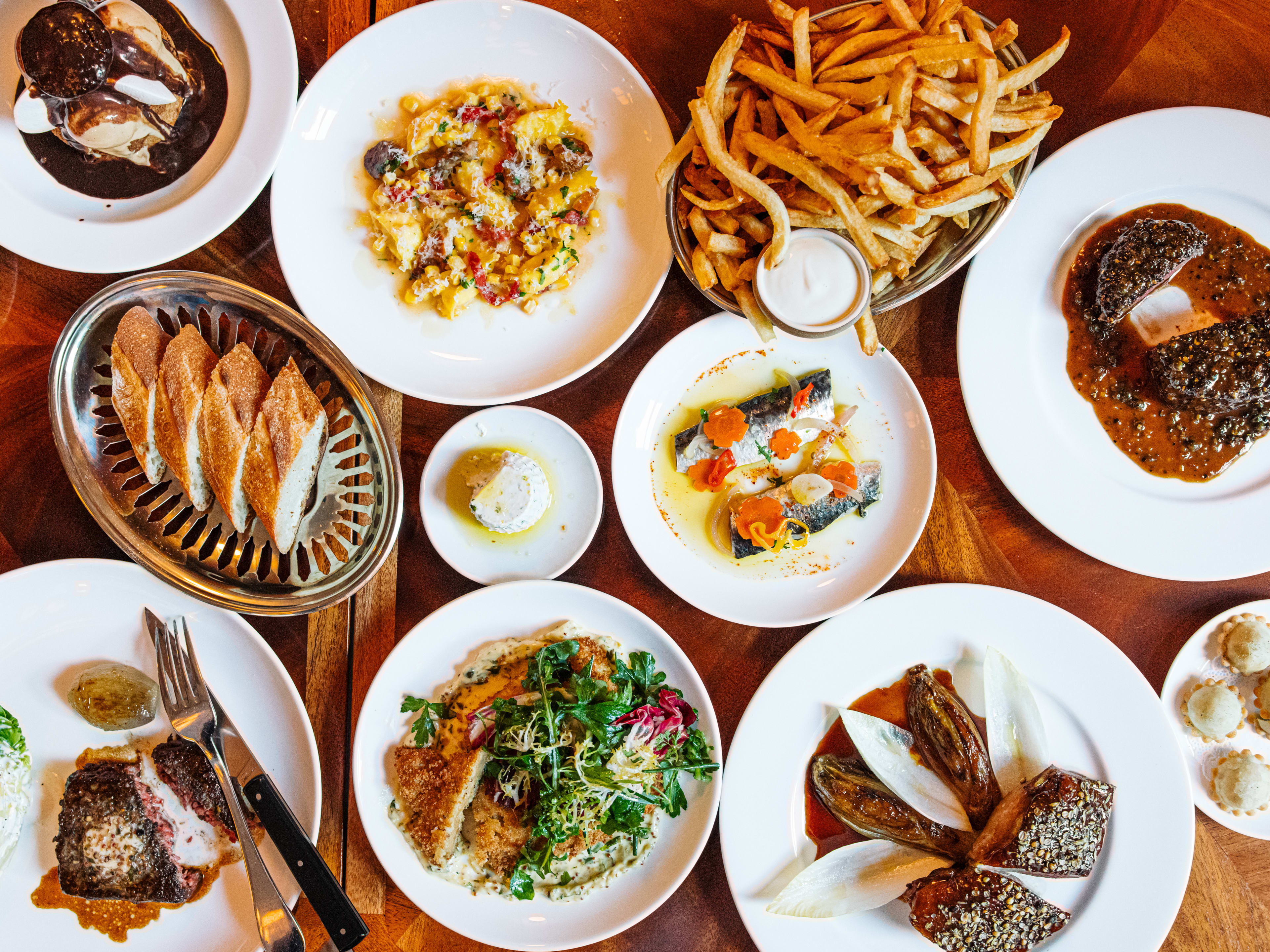 A big spread of fancy French food on a table.