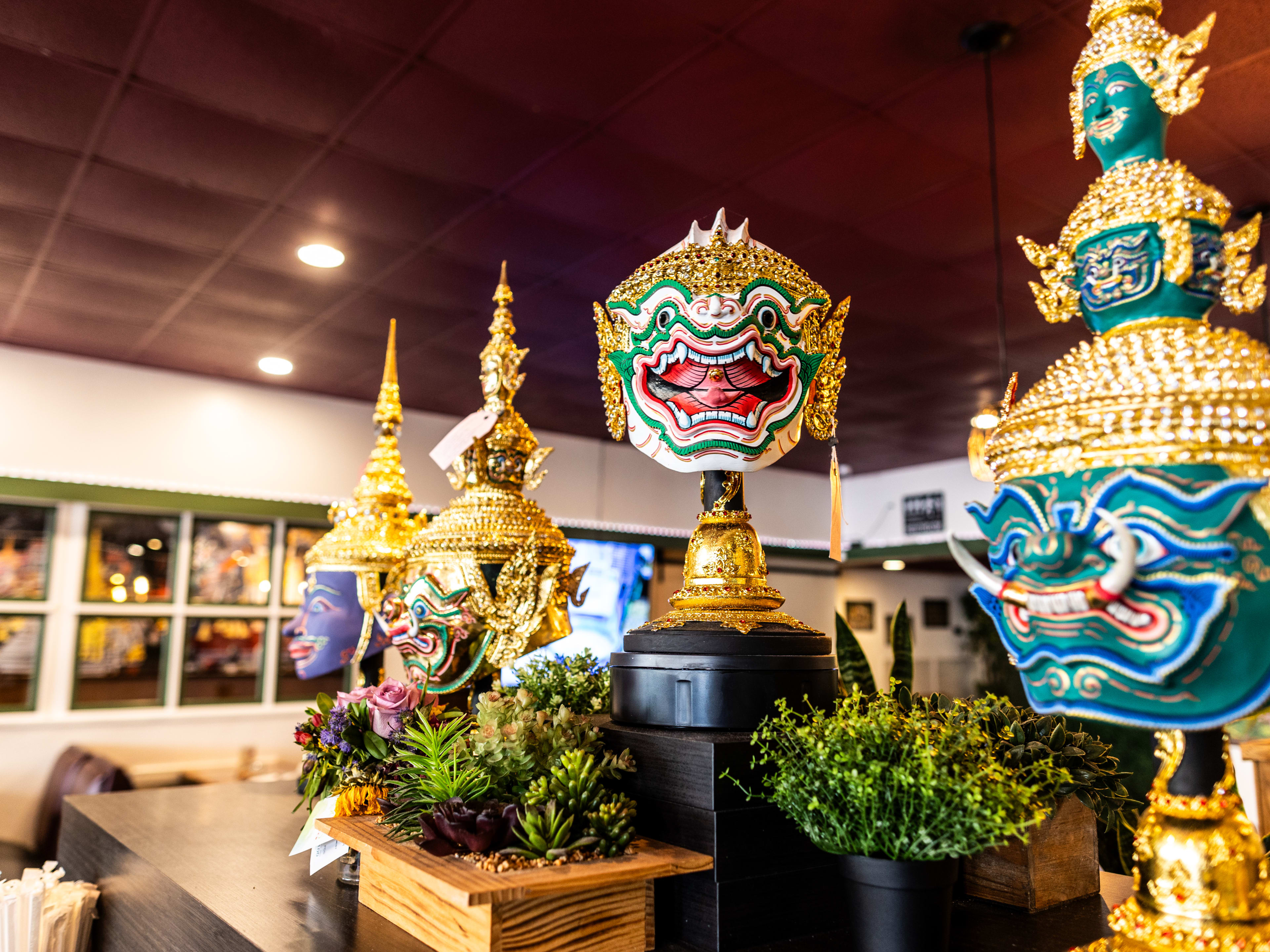 Decorative traditional statues inside Khon Thai.