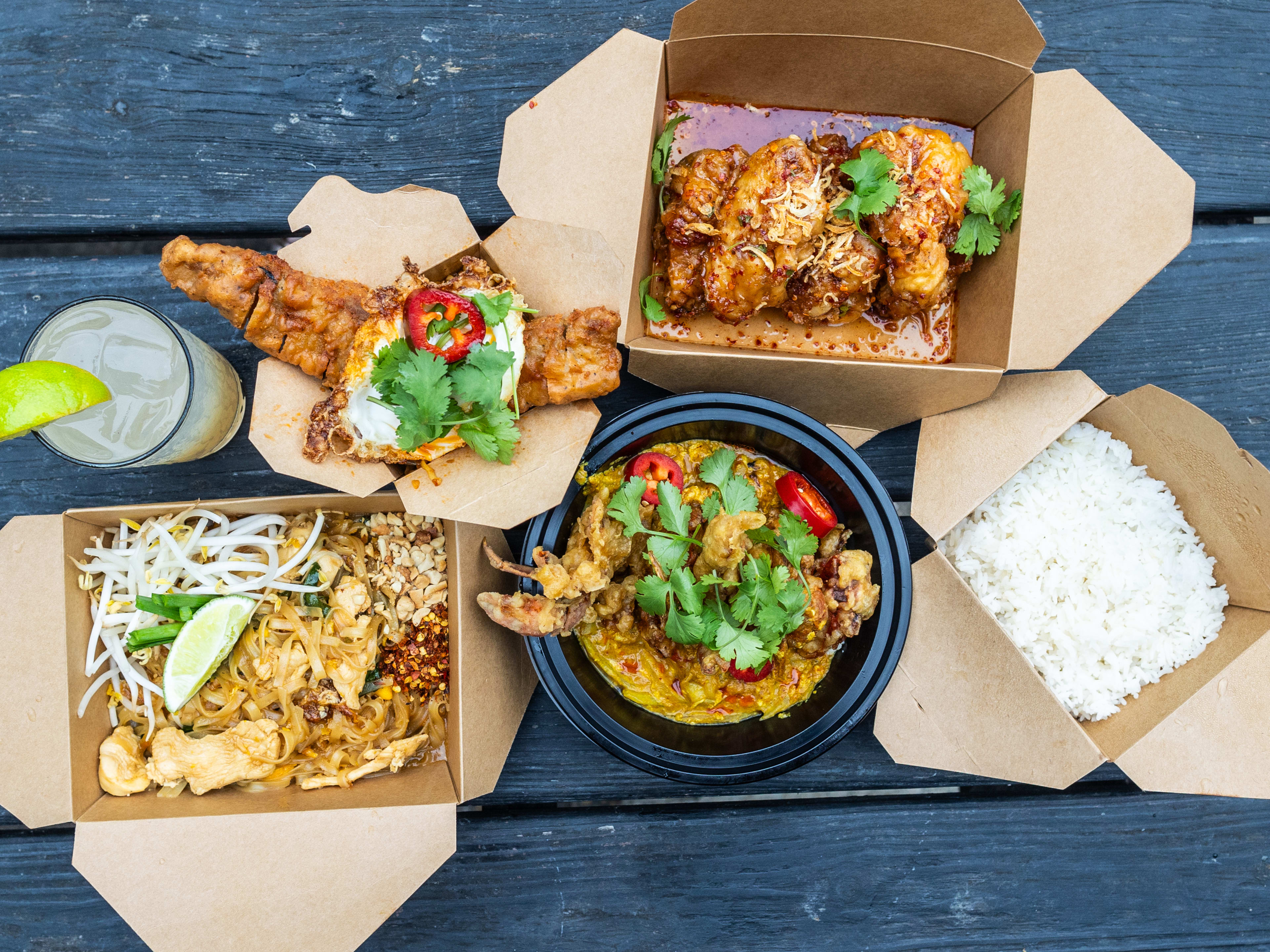 A spread of dishes in takeaway containers from Kiin Di.