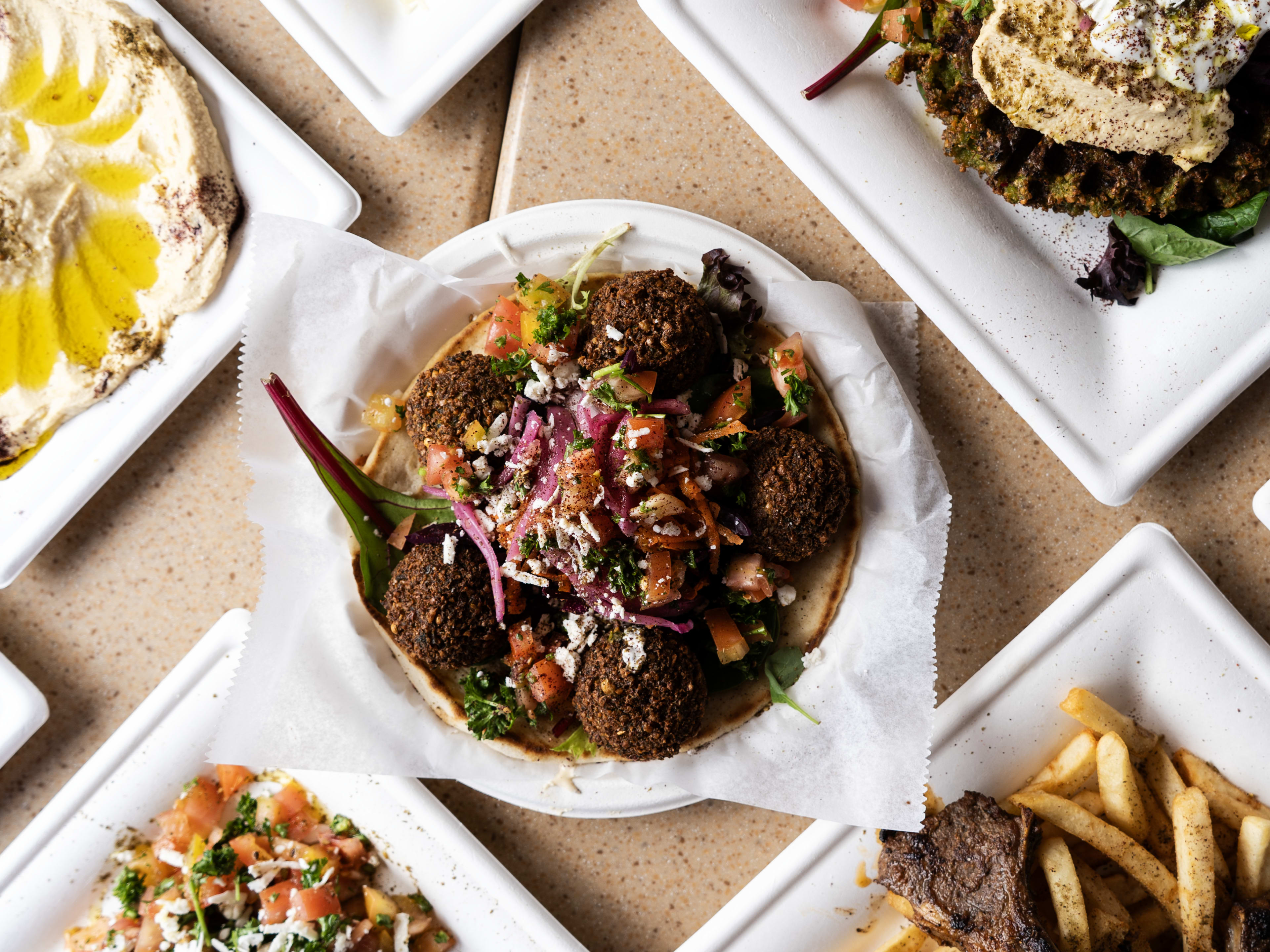 Spread of dishes including falafel, roasted eggplant, and dips at King Tut's