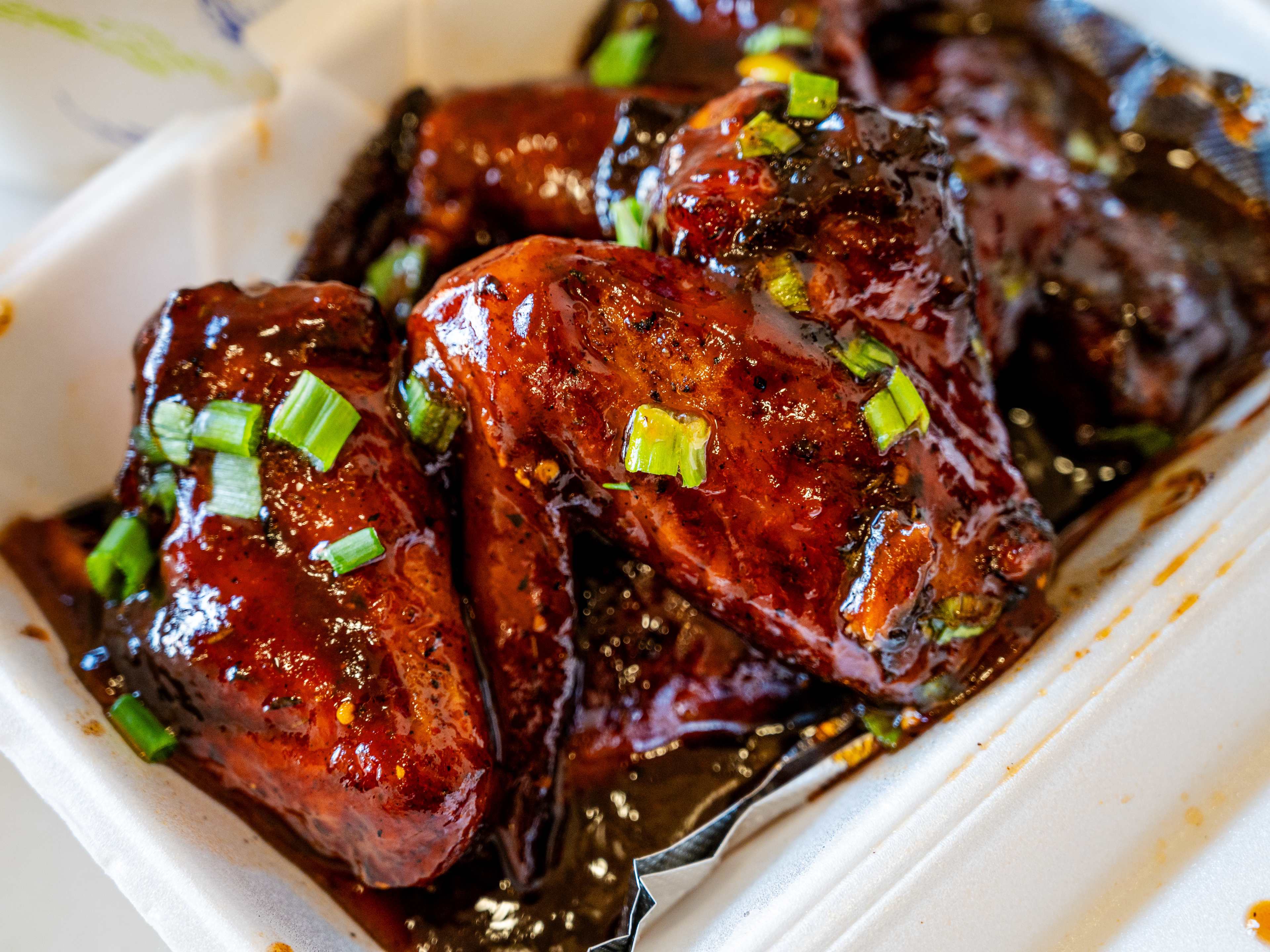 honey jerk chicken wings with sticky glaze and garnish