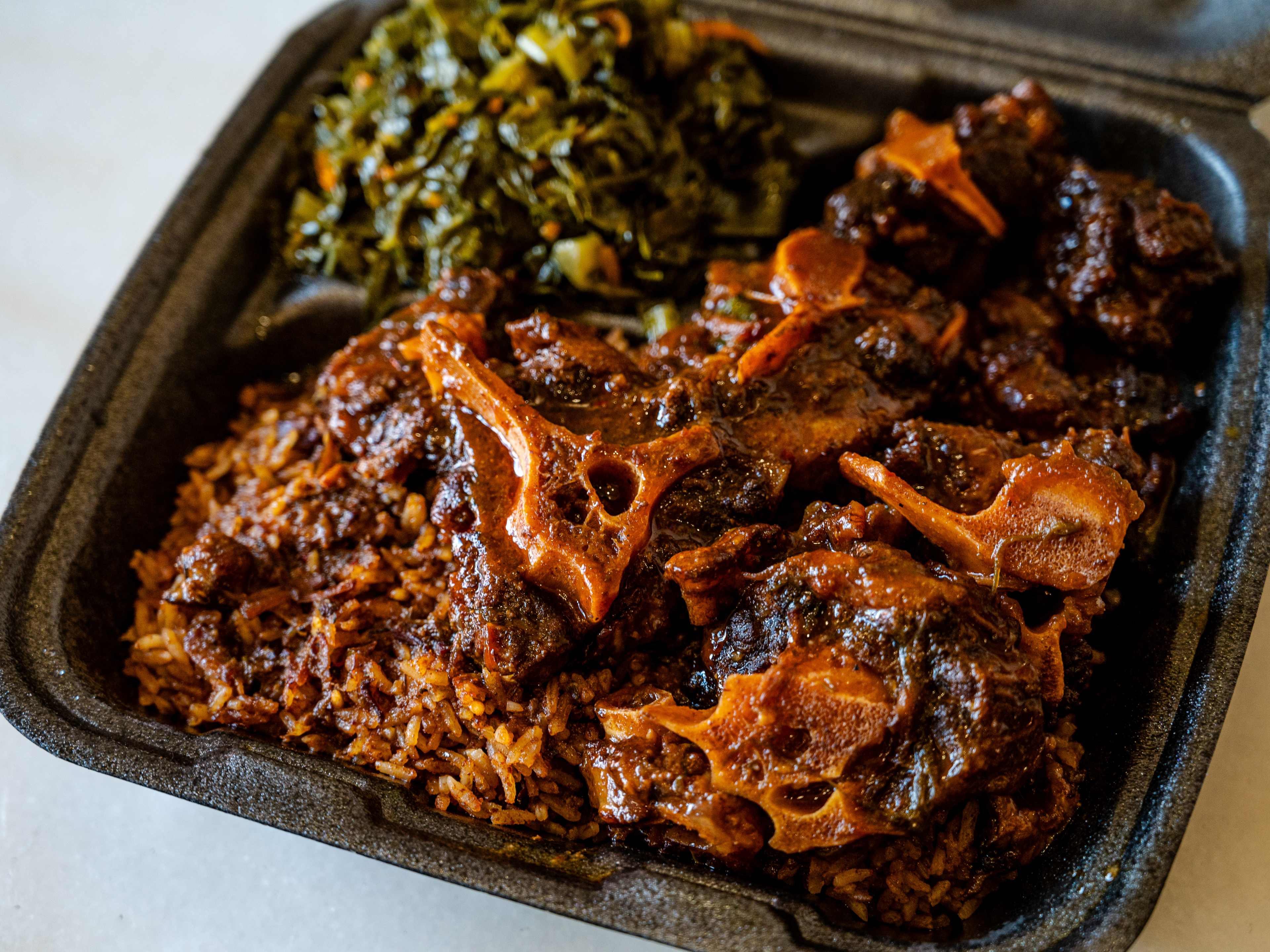 oxtails takeout plate with rice and greens