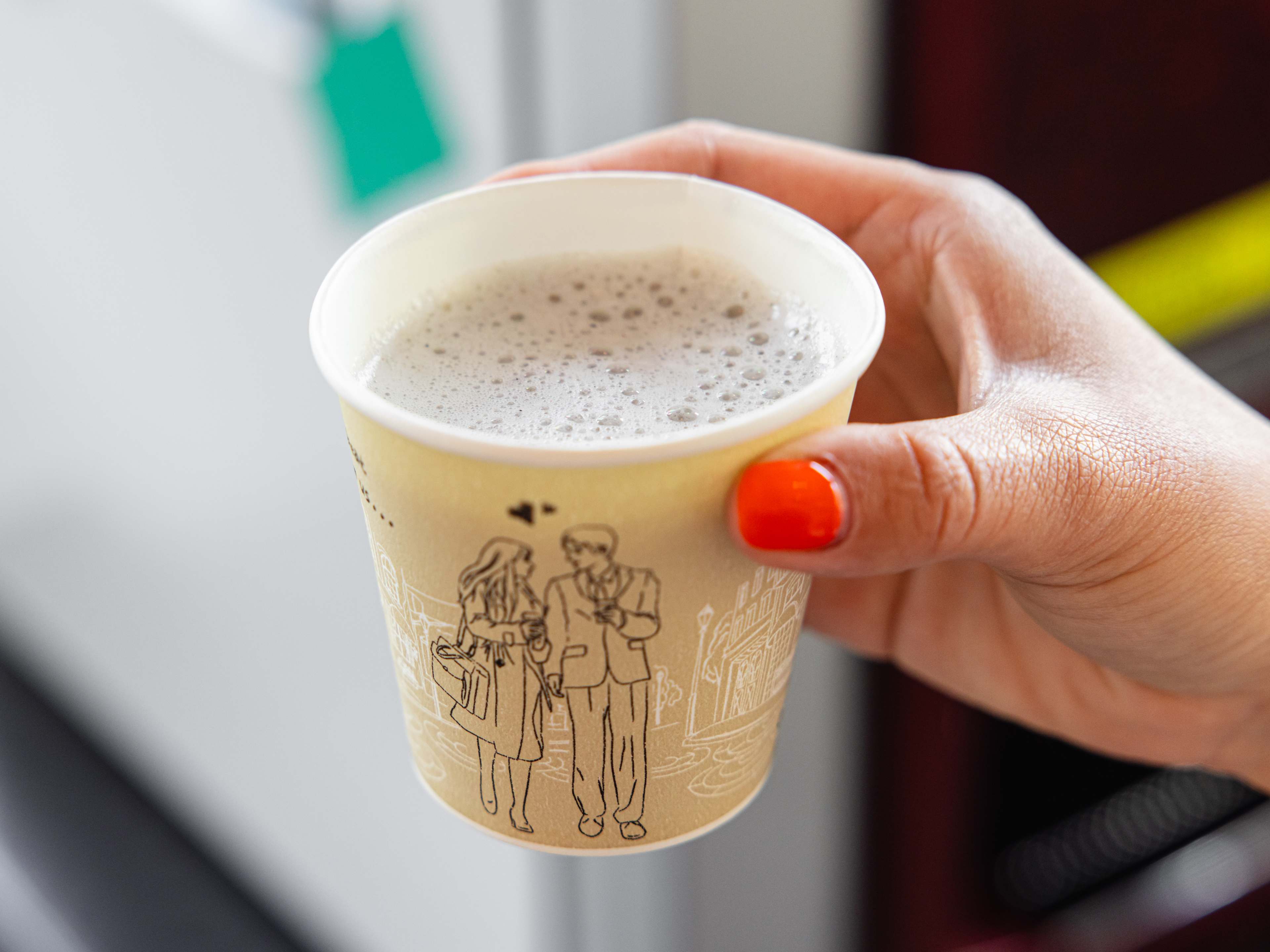 A latte in a paper cup.