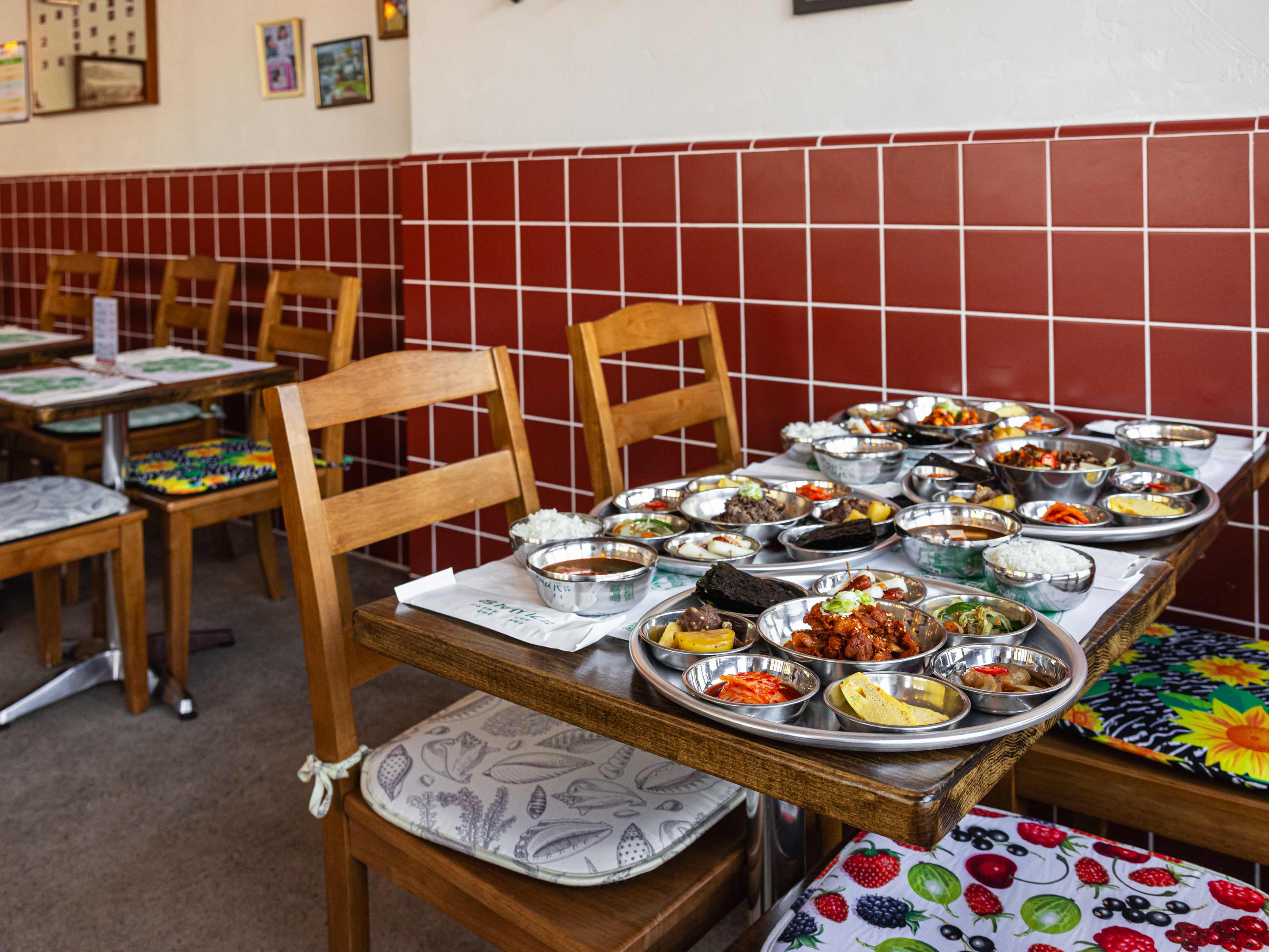 A table covered in trays of Korean food.