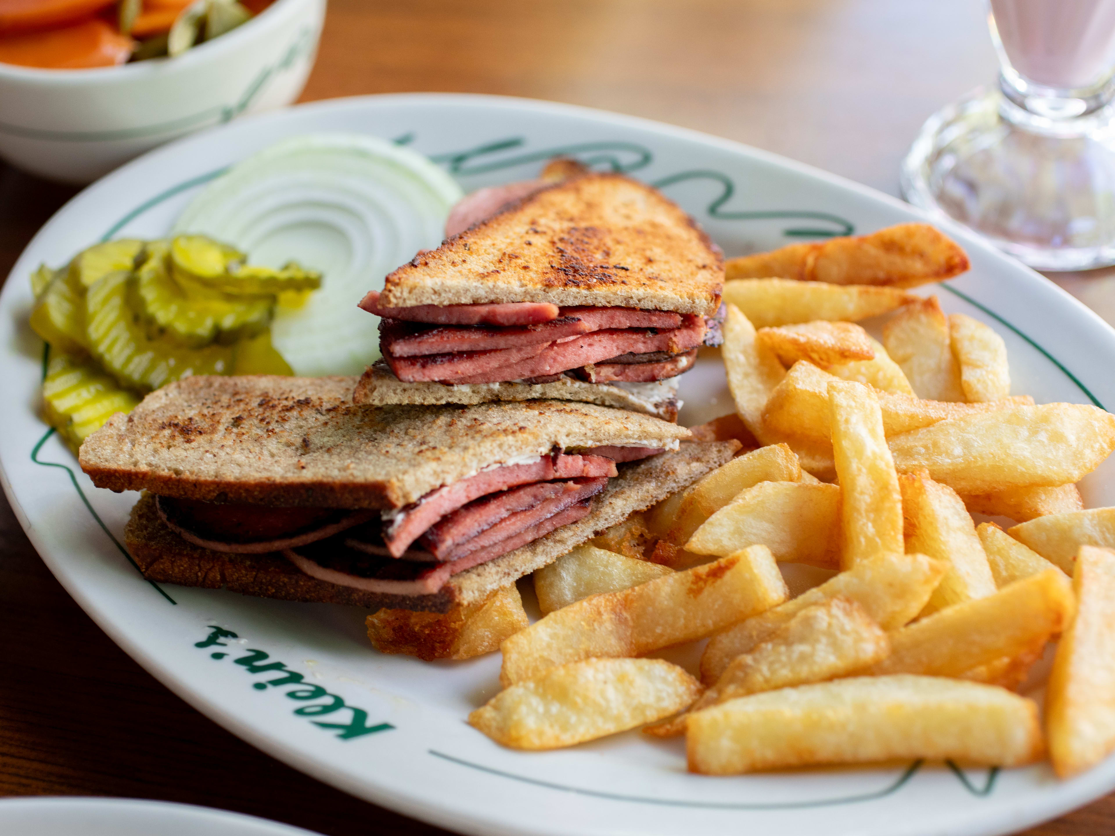 A sandwich and fries on a plate at Klein's, a restaurant in Mexico City