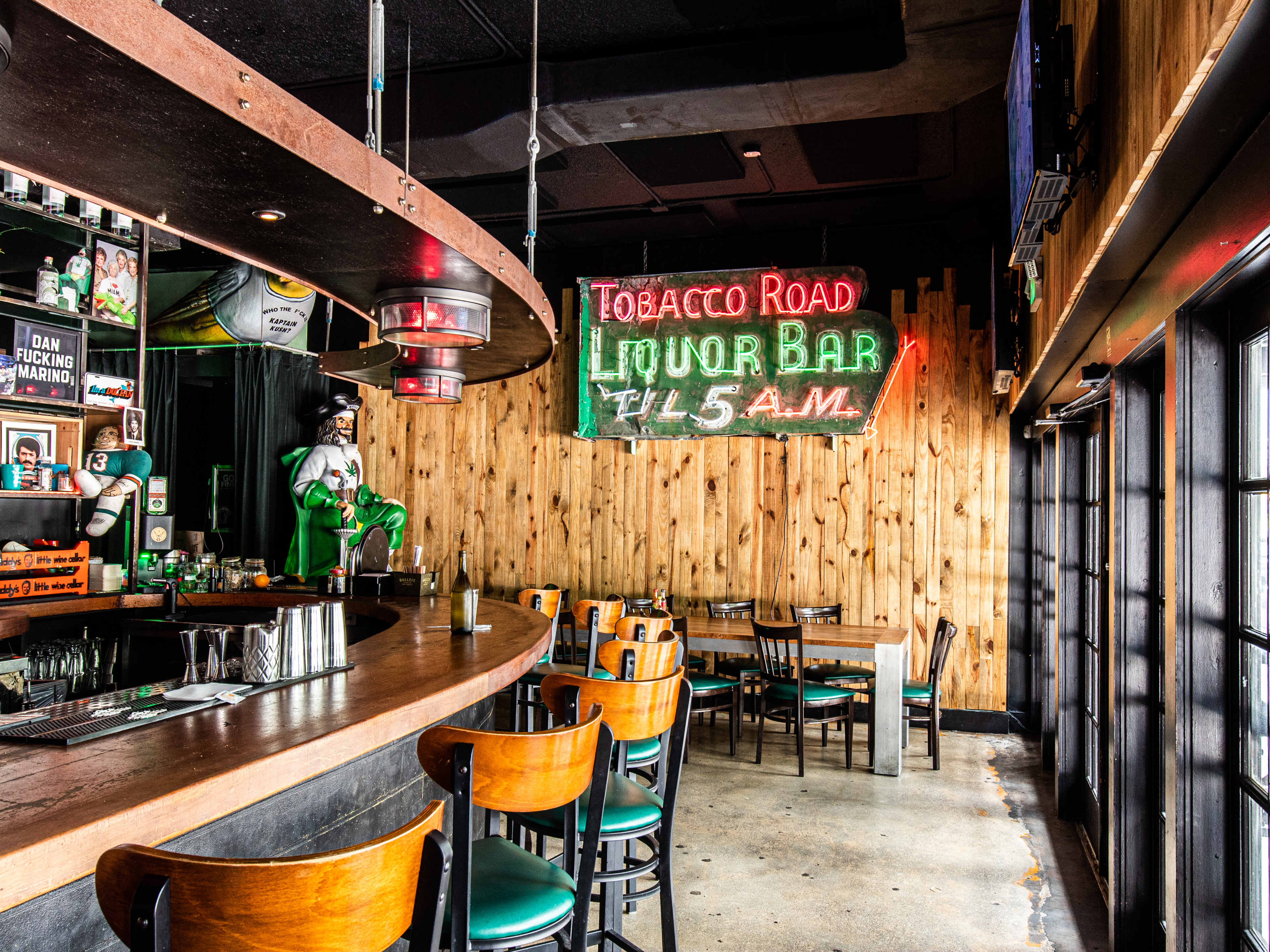 interior of old school bar with neon signs and wooden walls