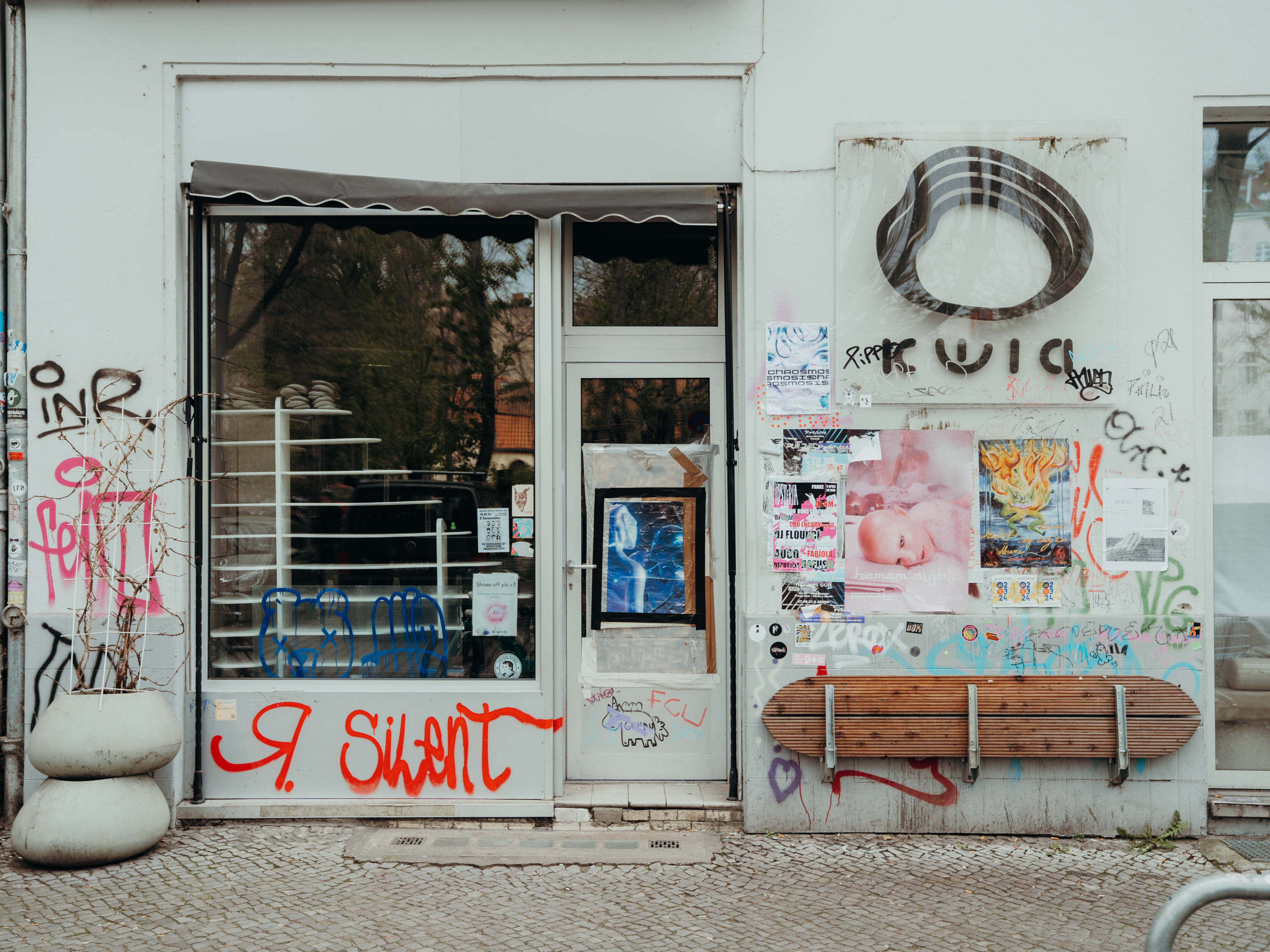 White painted exterior of Kwia covered with graffiti