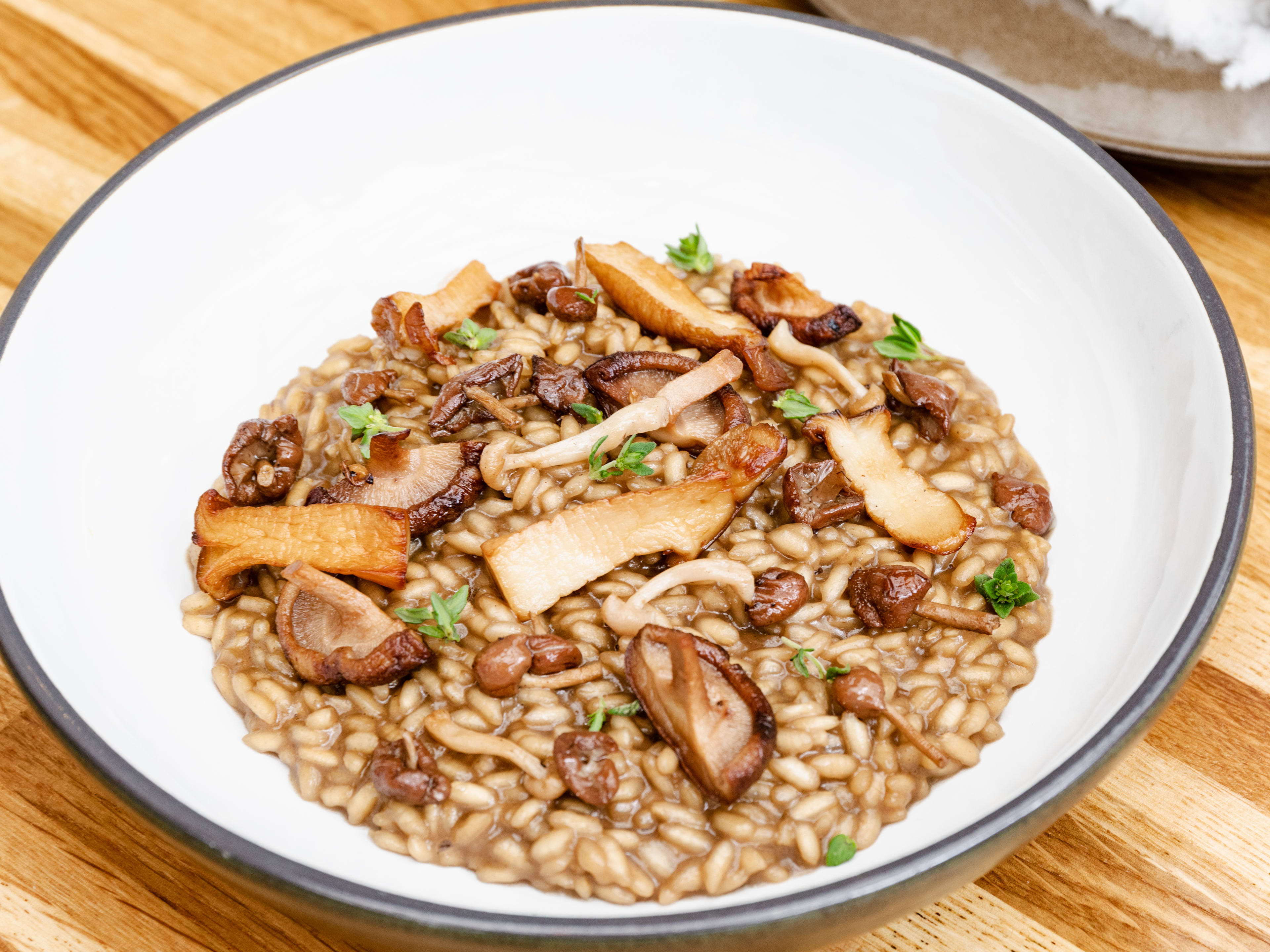 Mushroom risotto served in a white bowl.