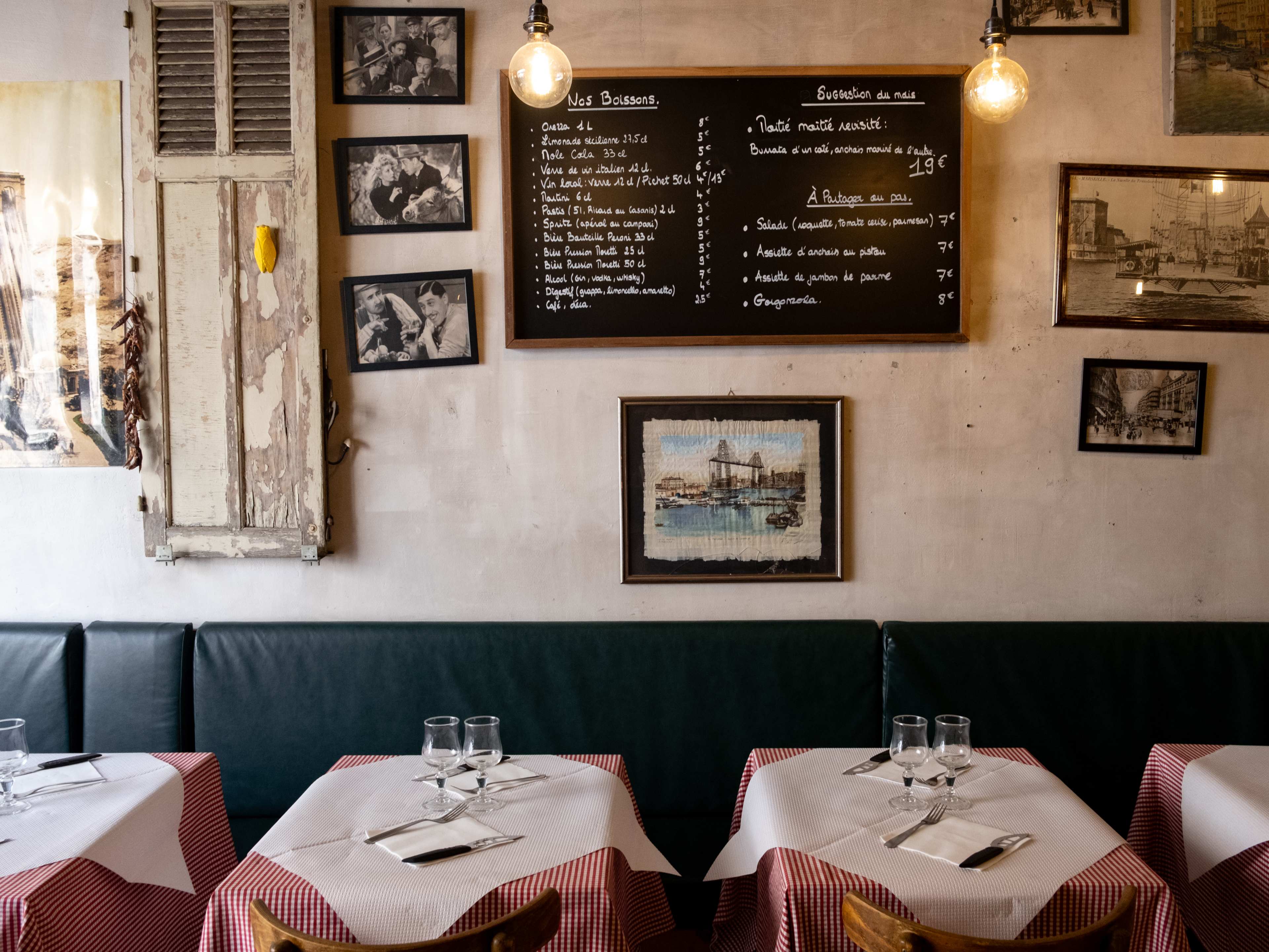 The bistro-looking interior with bench seating inside a restaurant in Marseille