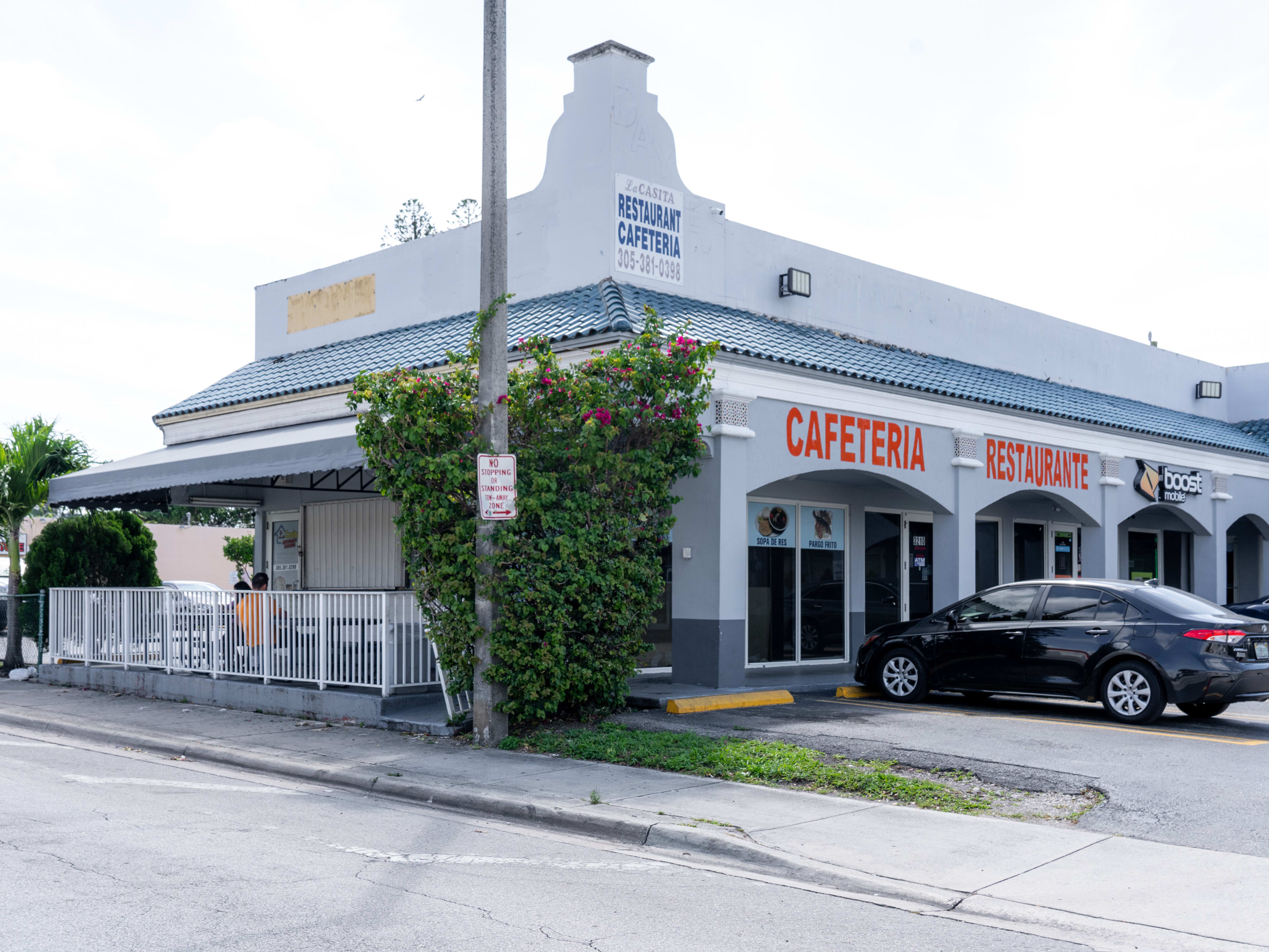 blue restaurant exterior attached to strip mall with "cafeteria restaurante" written in giant bold red letter.