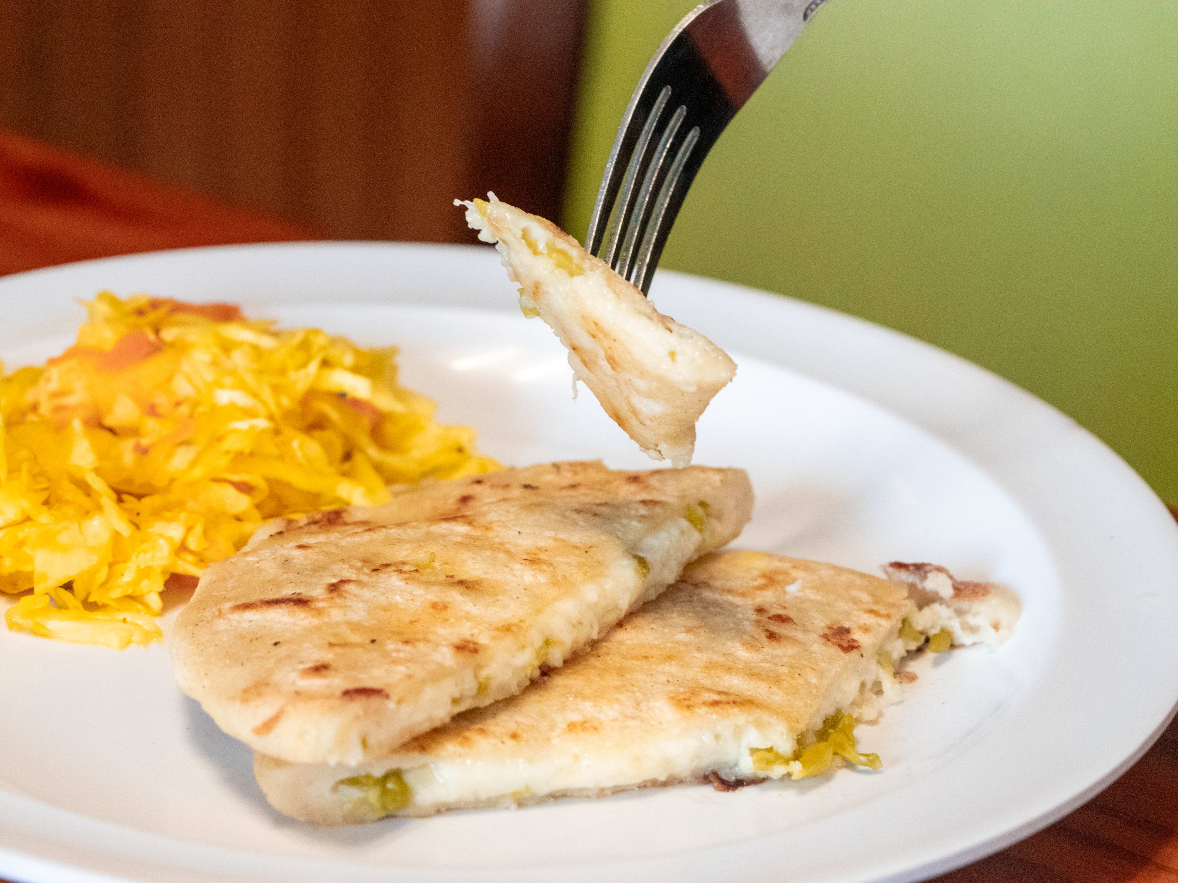 Pupusa with loroco and cheese and a side of yellow cabbage