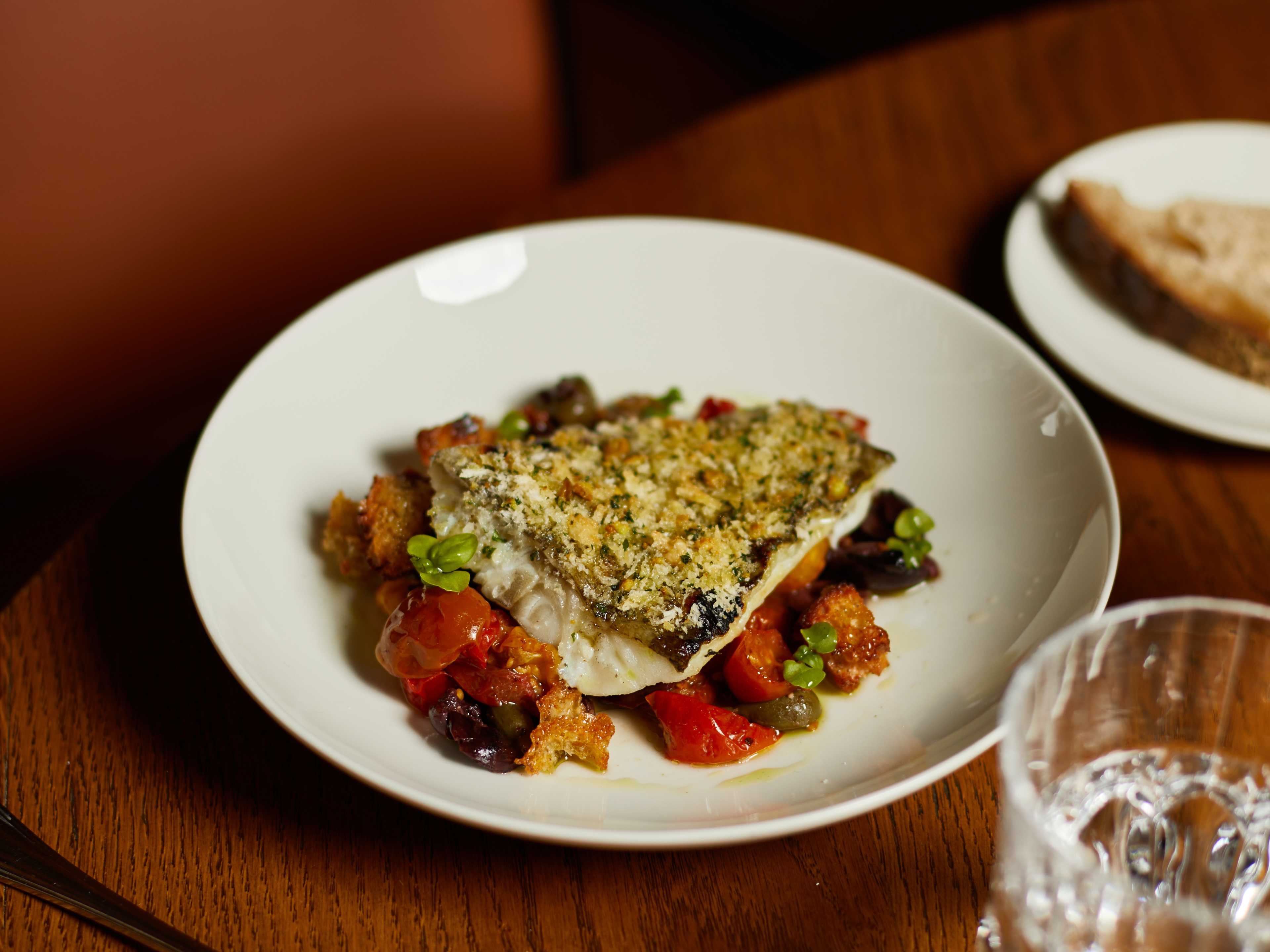 Grilled filet of fish topped with breading at La Dama