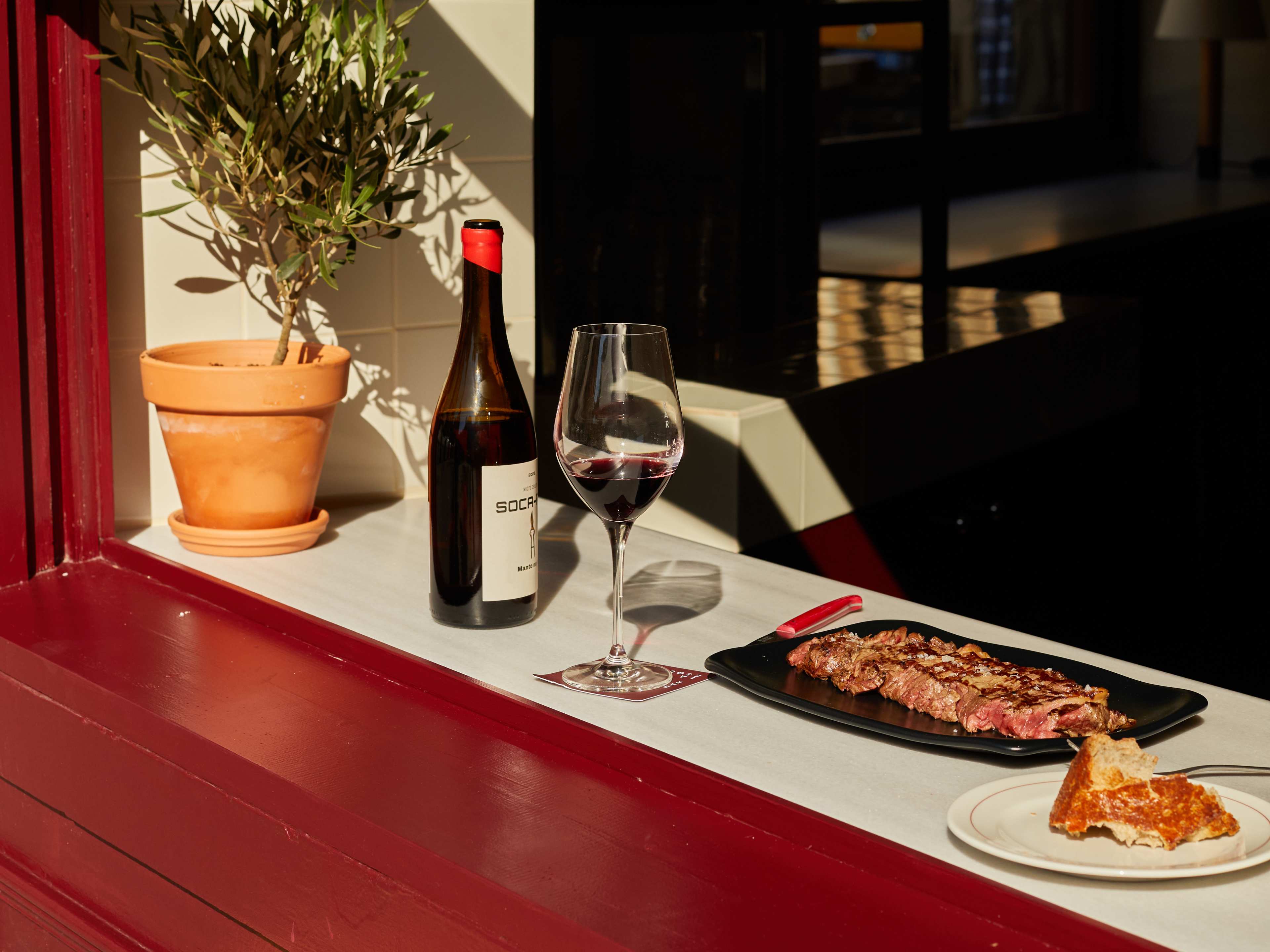 Spread of tapas dishes on red windowsill at La Esquina