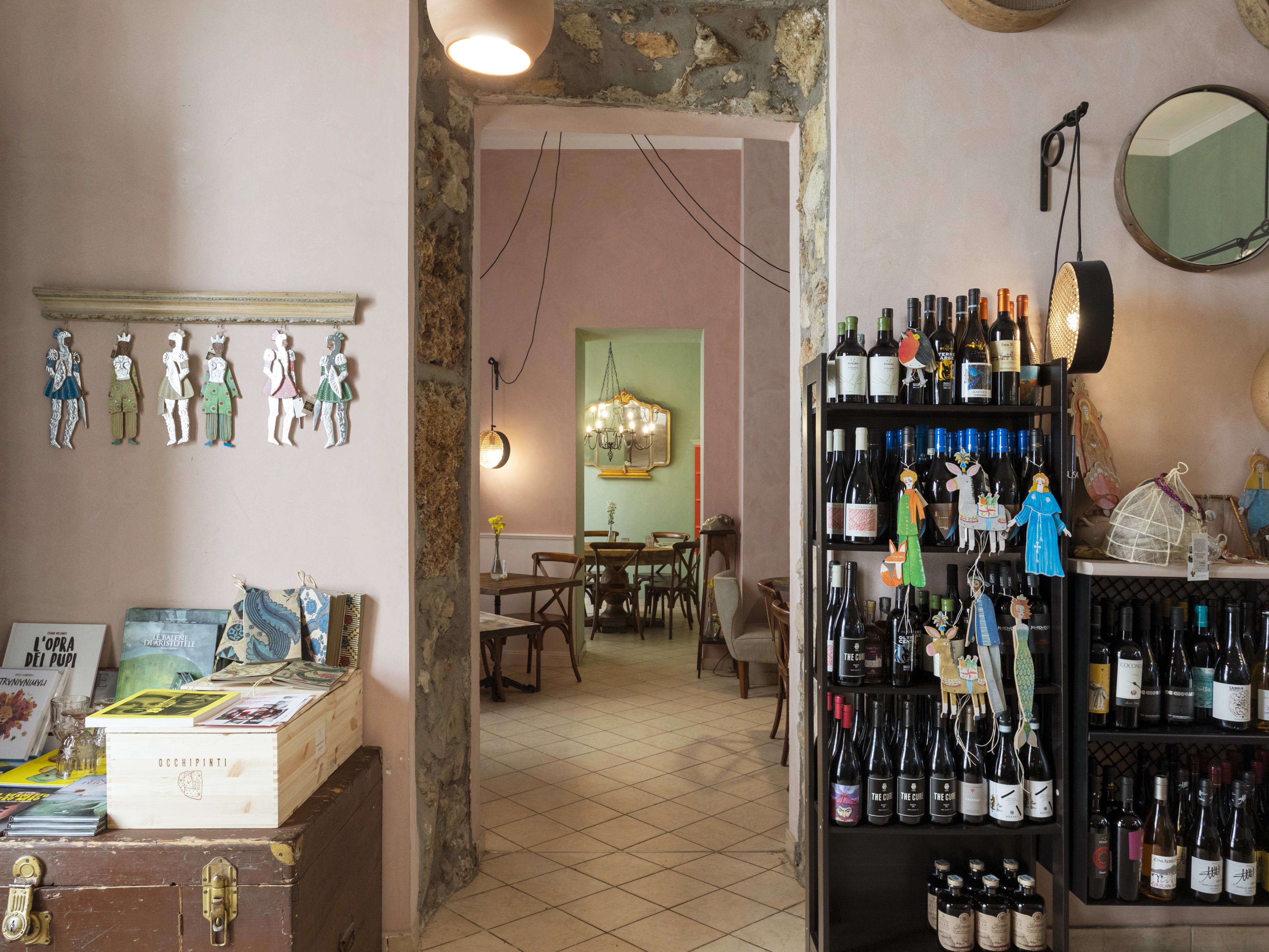 A small restaurant filled with wine bottles and other knick-knacks