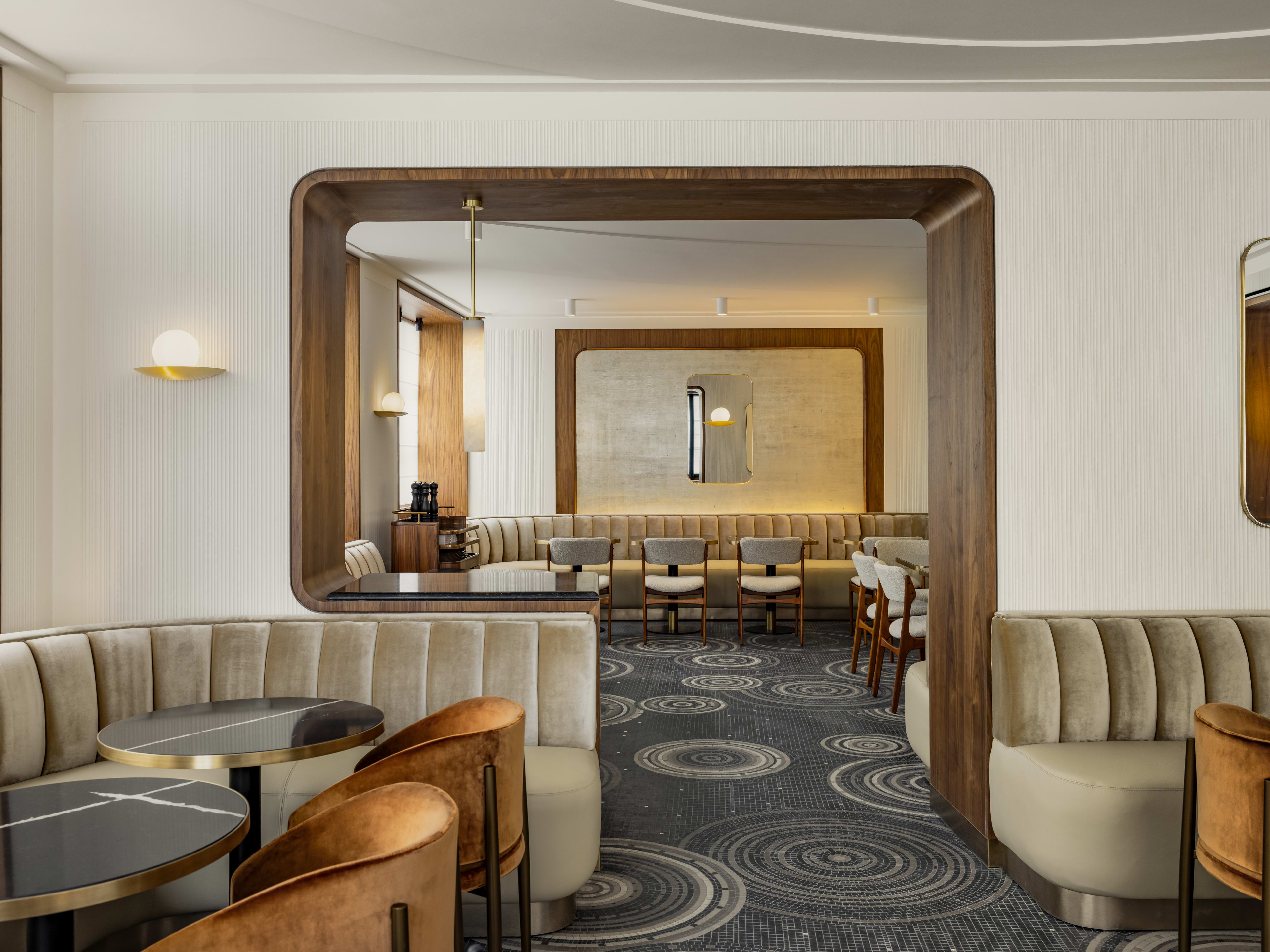 Interior lounge area with cream booths at Les Parisiens