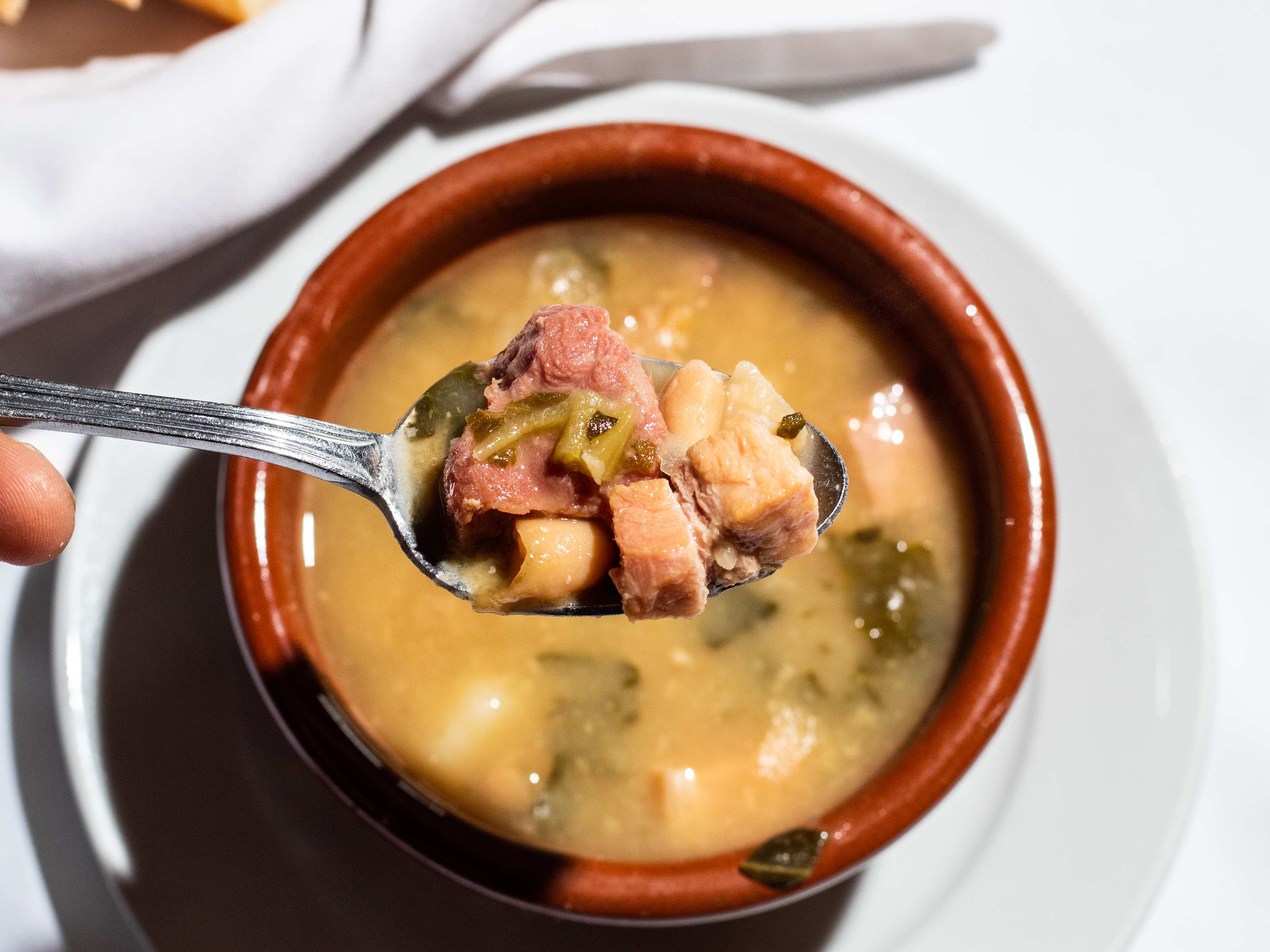 soup with spoon held up to show veggie and meat