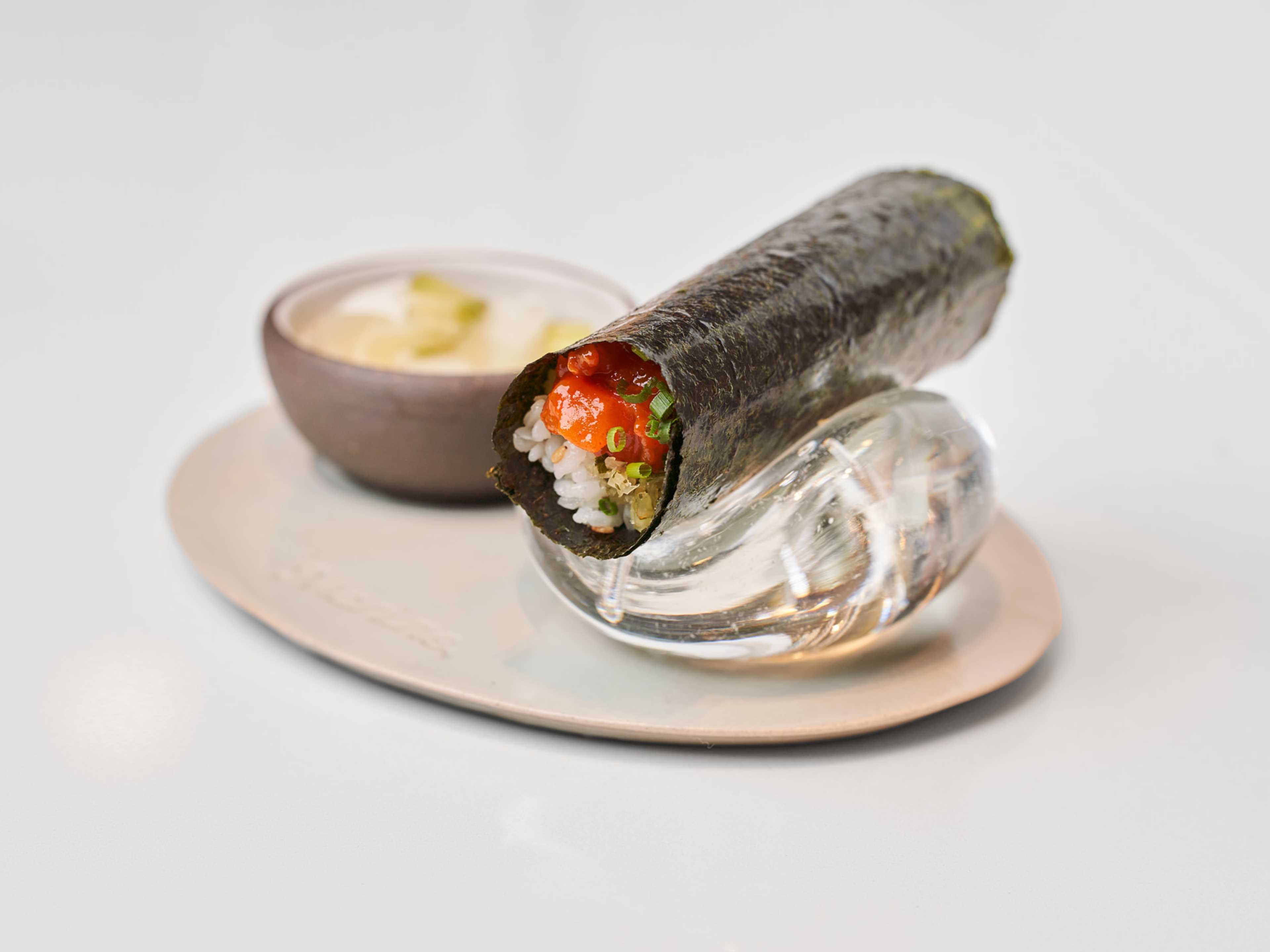 A handroll with rice and fish inside.