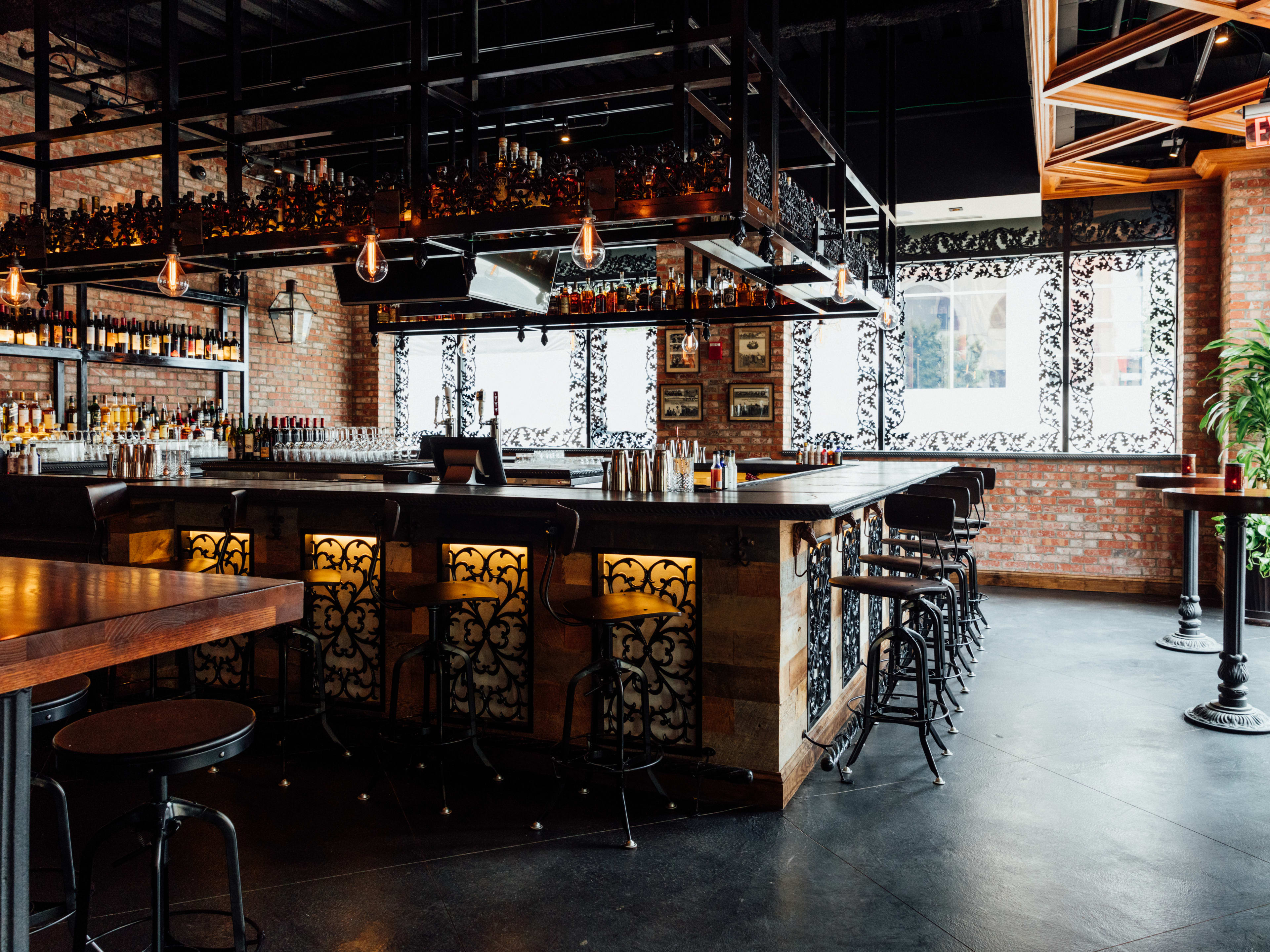 new orleans inspired restaurant interior with wrought iron details and bar