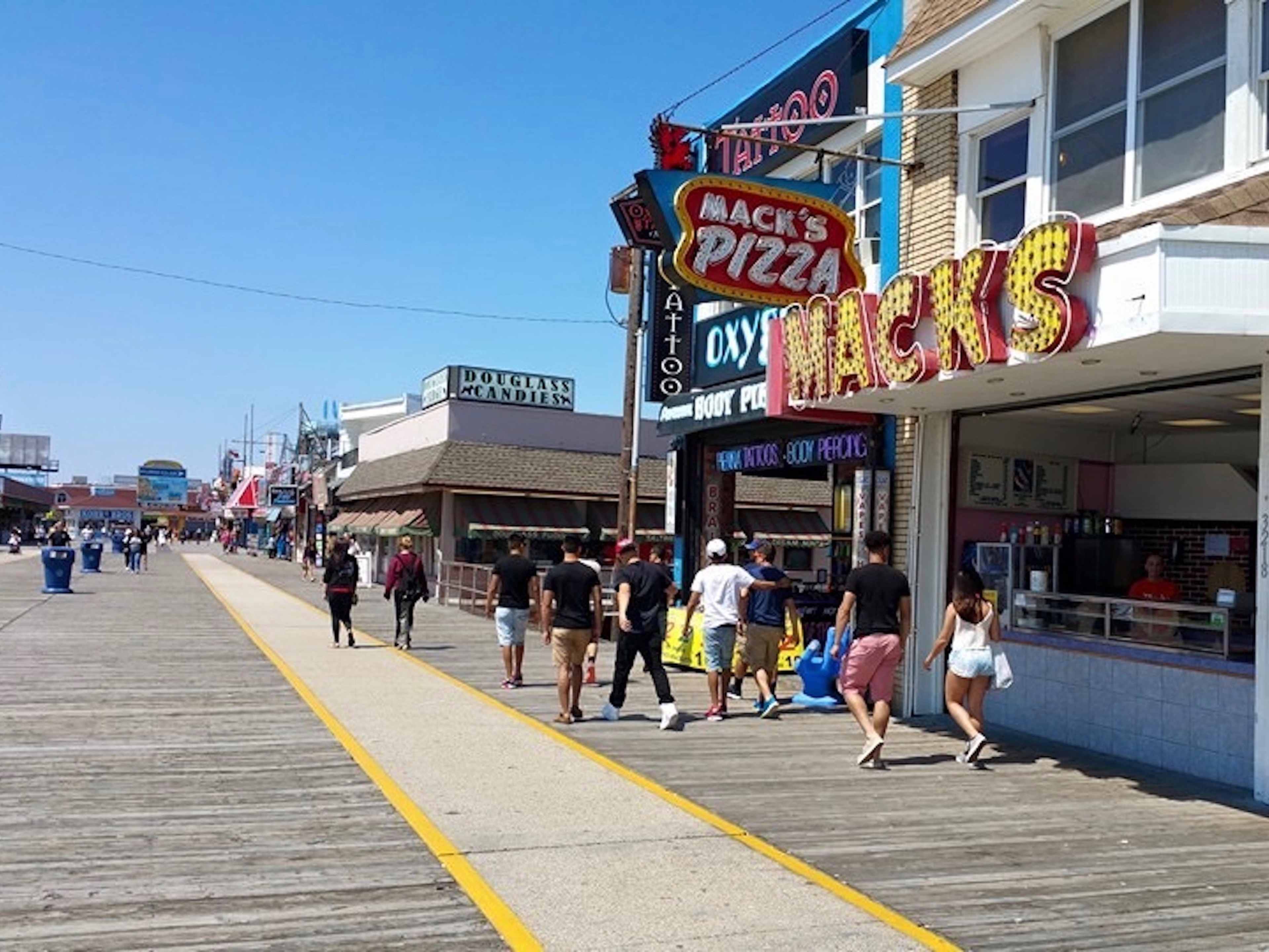 pizza shop with colorful signage on beach boardwalk