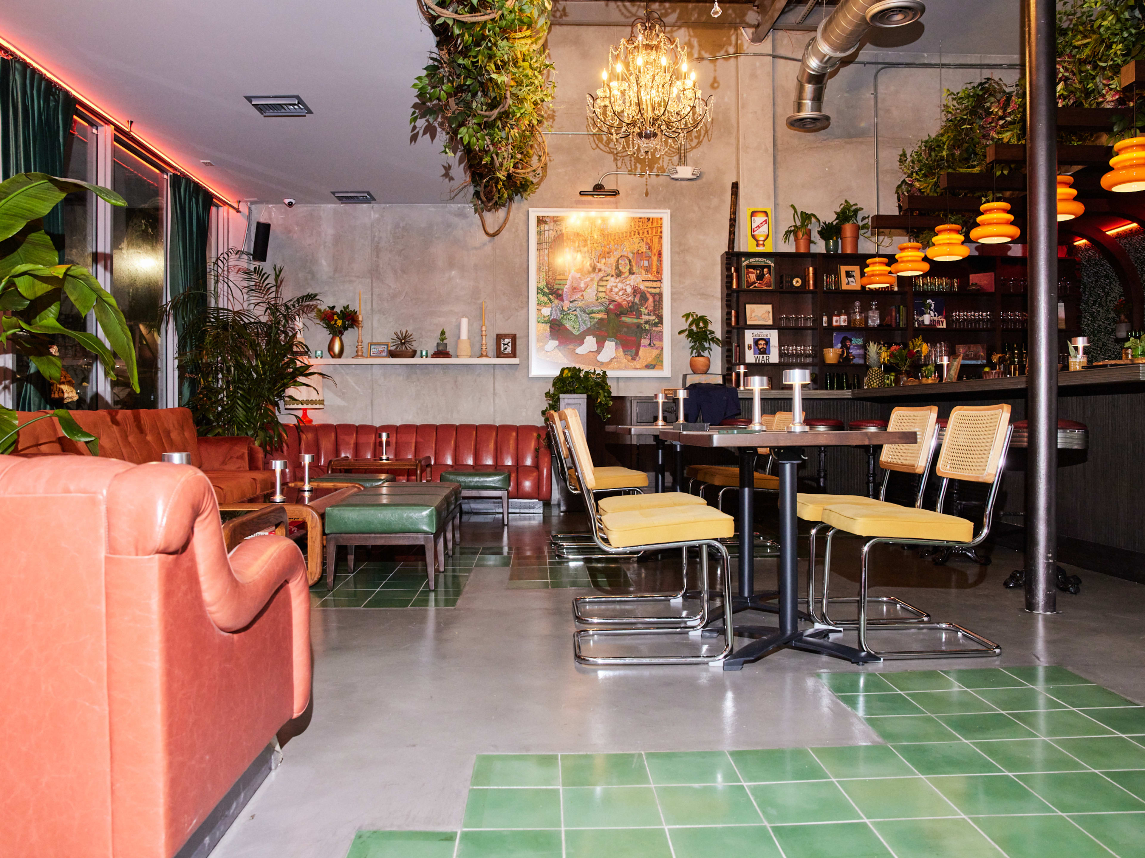 A lounge with pink sofas and a few tables.