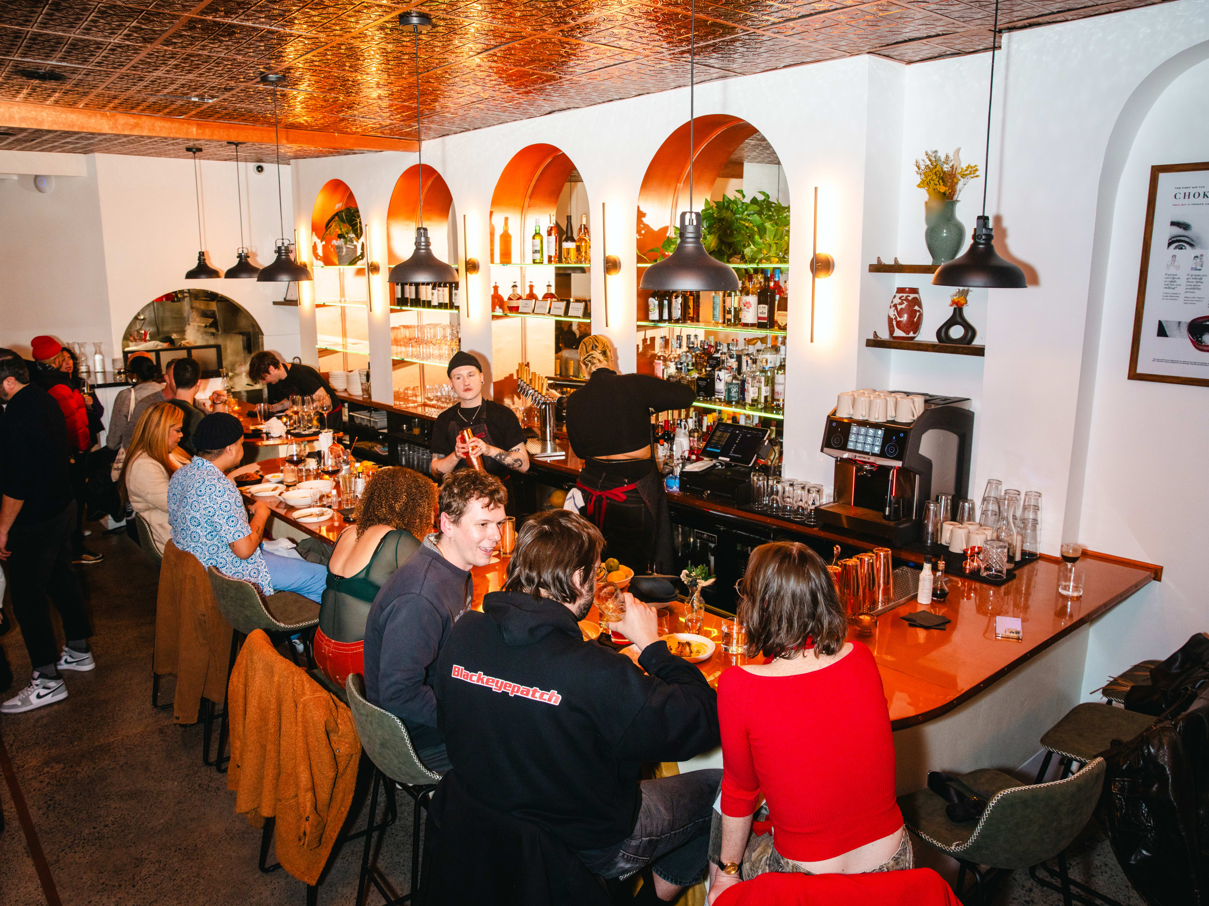 People sitting around the bar at Marie's in Bushwick.