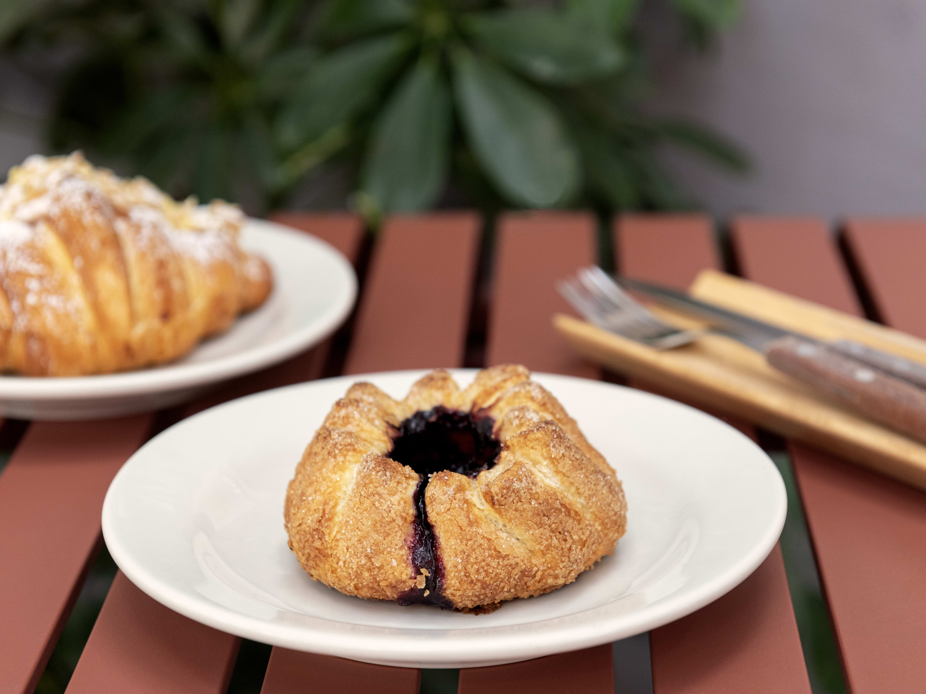 Volcan pastry and almond croissant on white plates at Marne