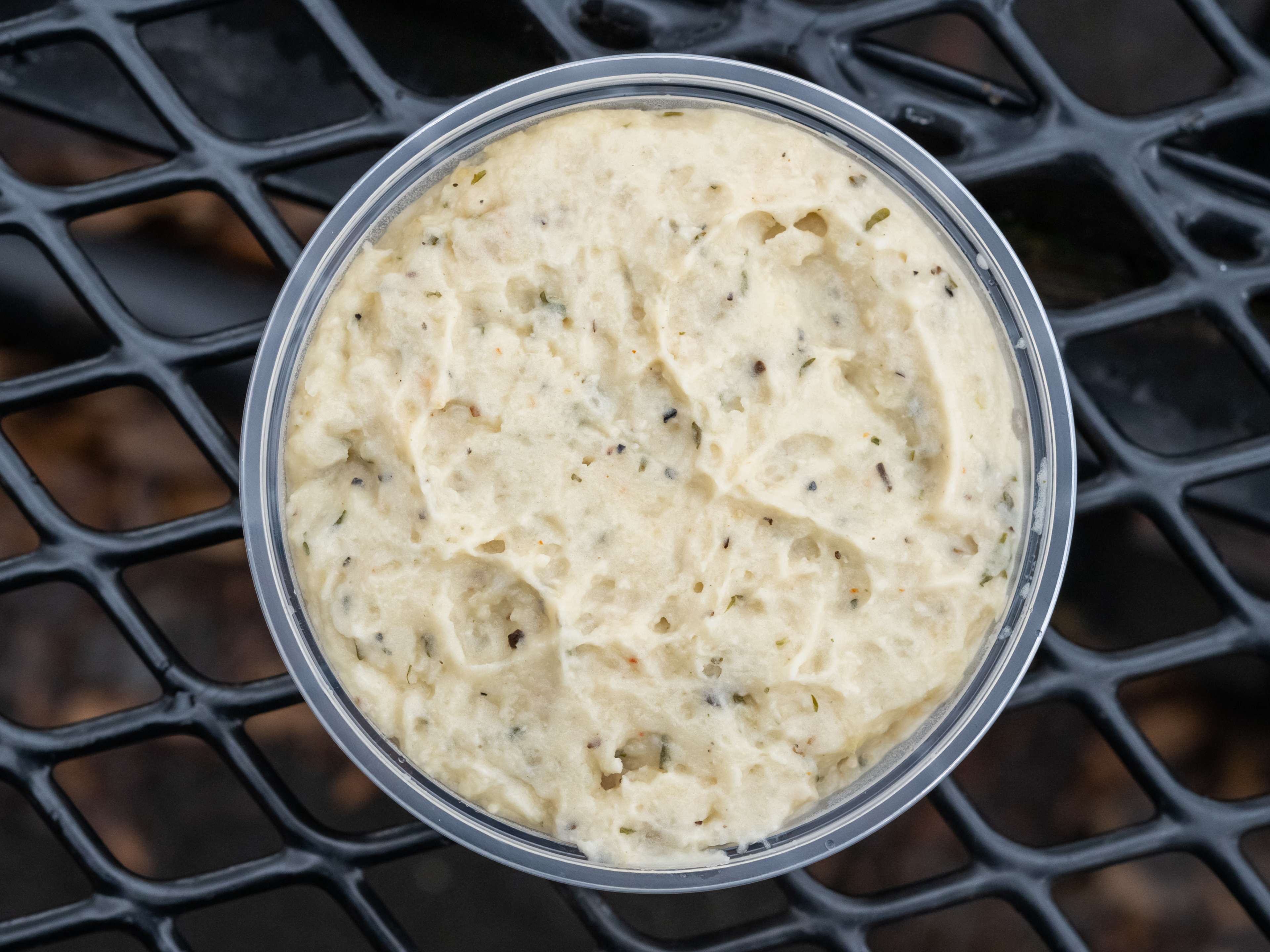 garlic mashed potatoes in a takeout deli container