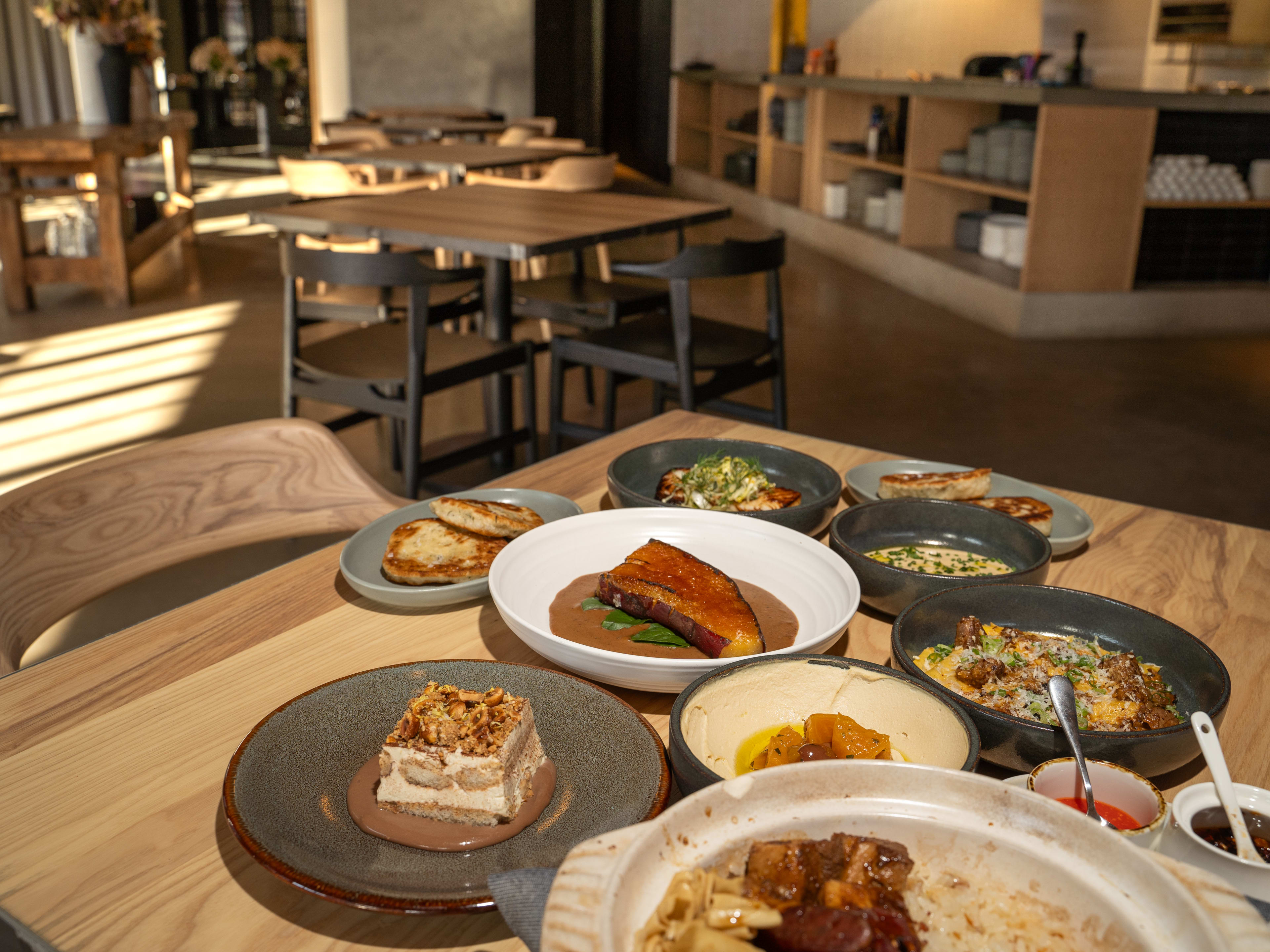 A spread of food at Maxwells Trading with sweet potato, French onion dip, and scallion pancakes.