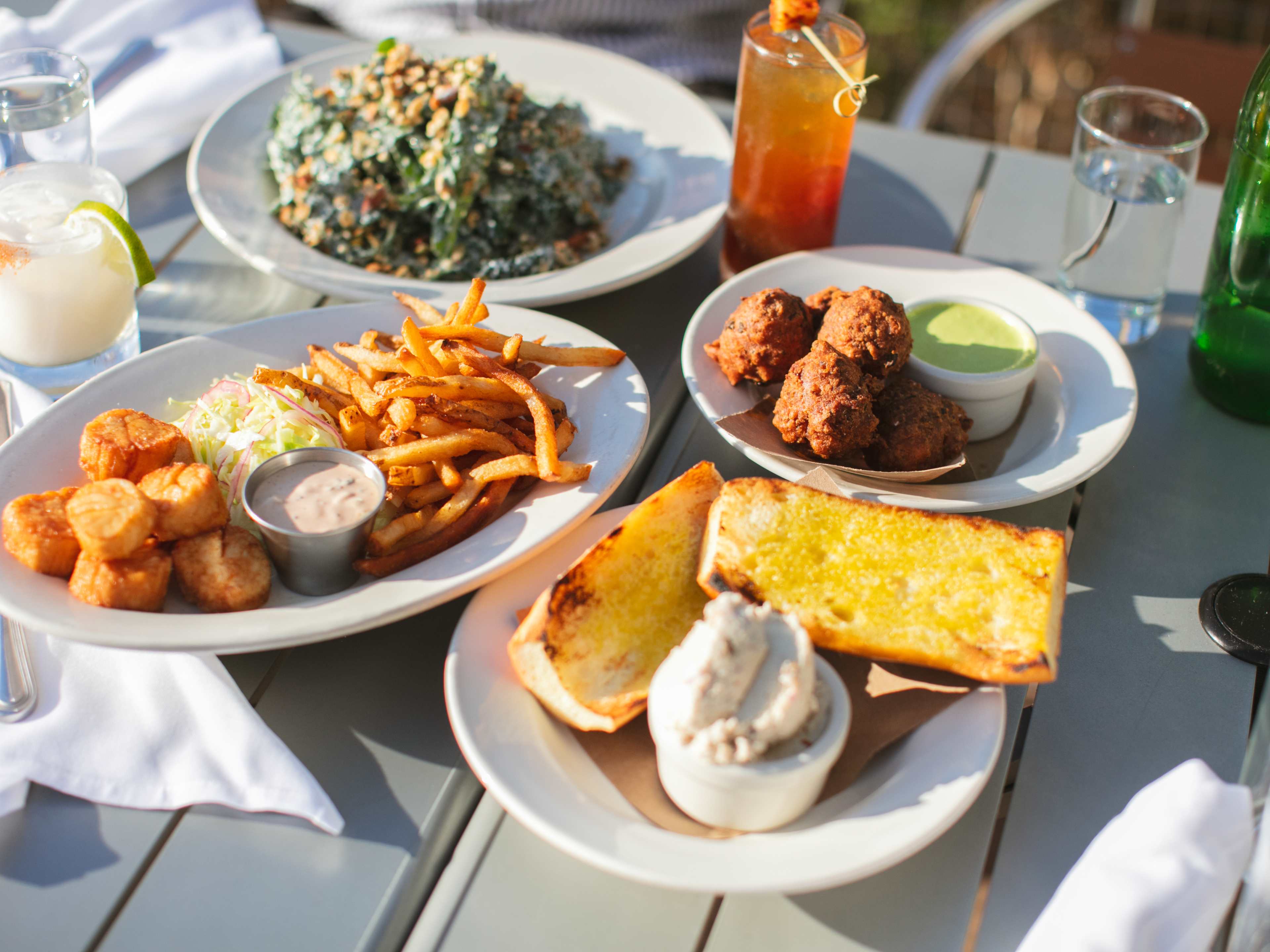 An overhead shot of various dinner dishes on a white table cloth