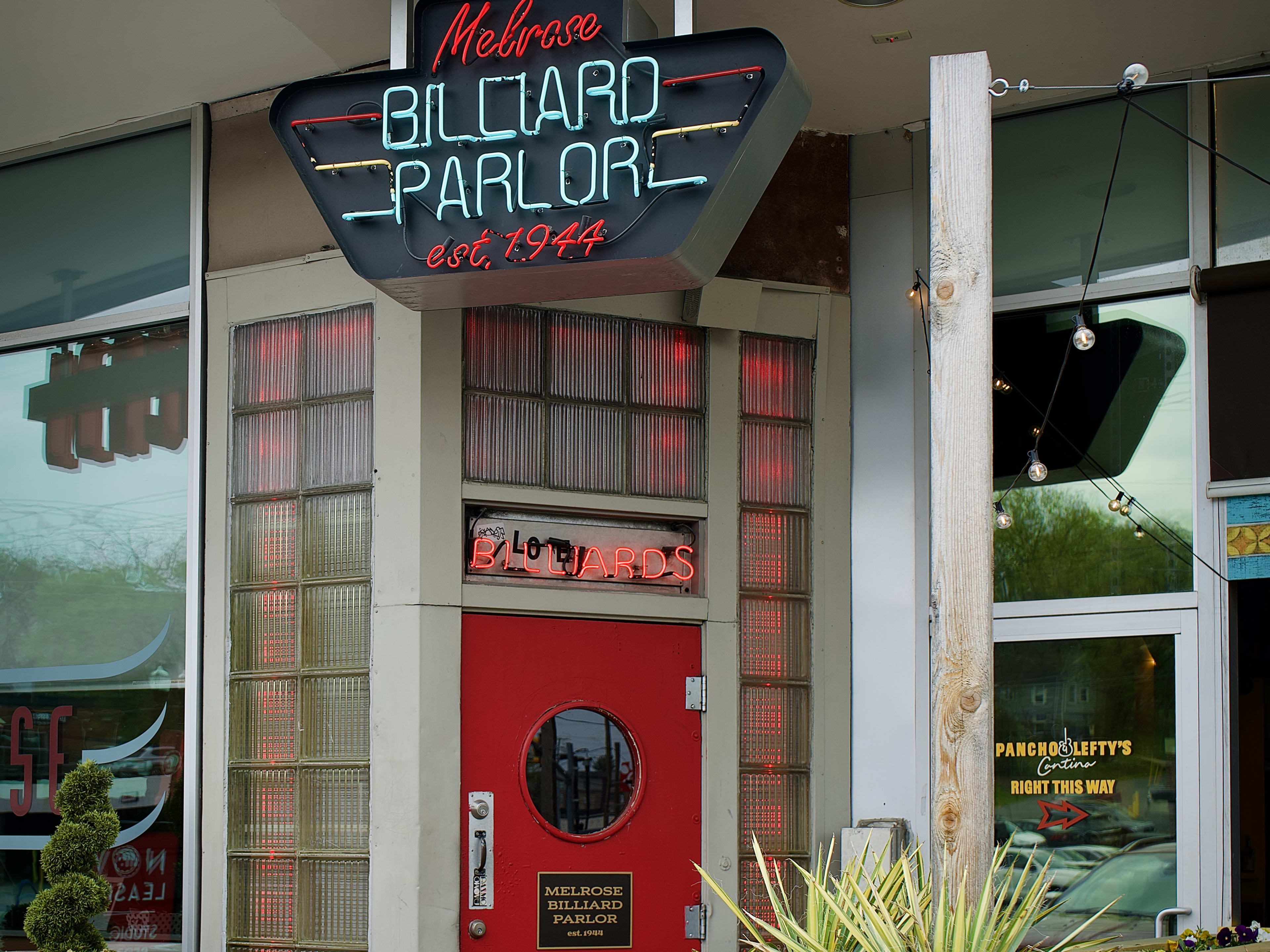 Exterior of Melrose Billiard Parlor with red and blue neon signage