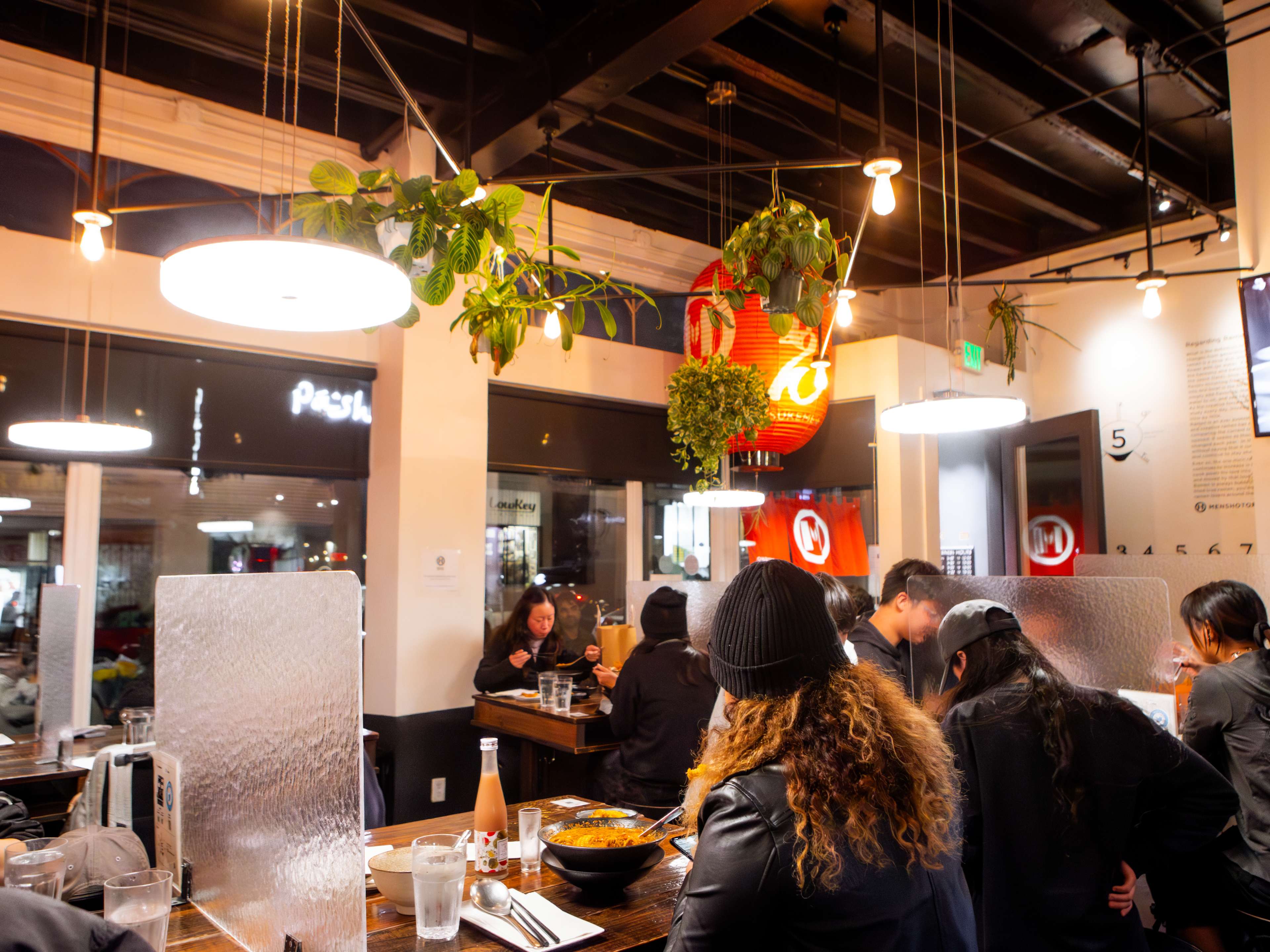 The dining room with tables and partitions at Mensho