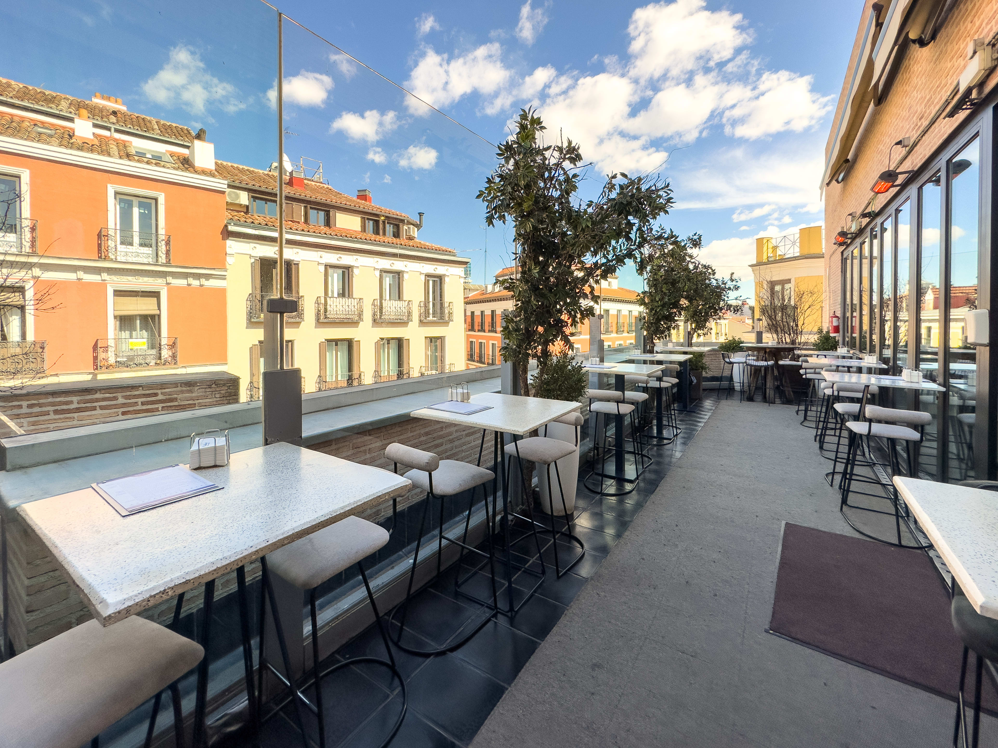 Outdoor dining area on balcony of Mercado de San Antón