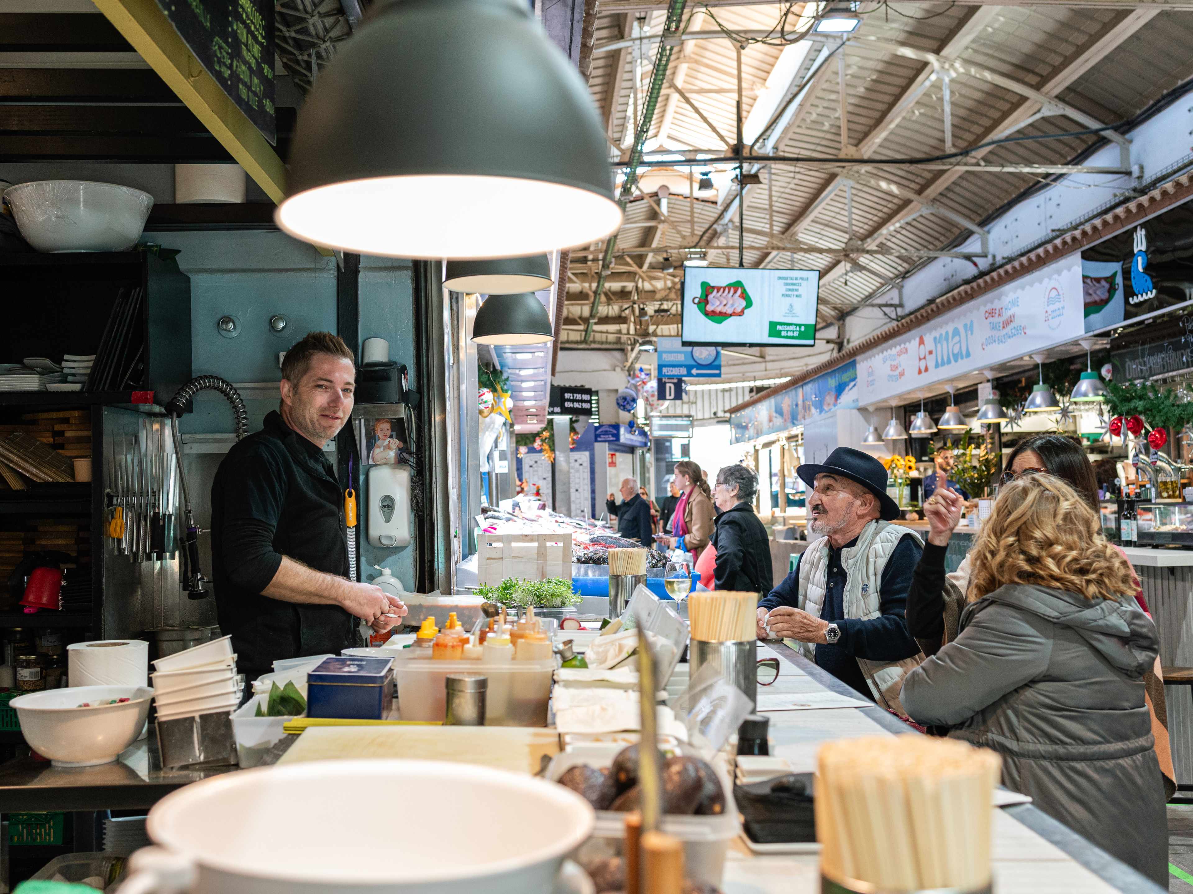 indoor market interior with people sitting at counter