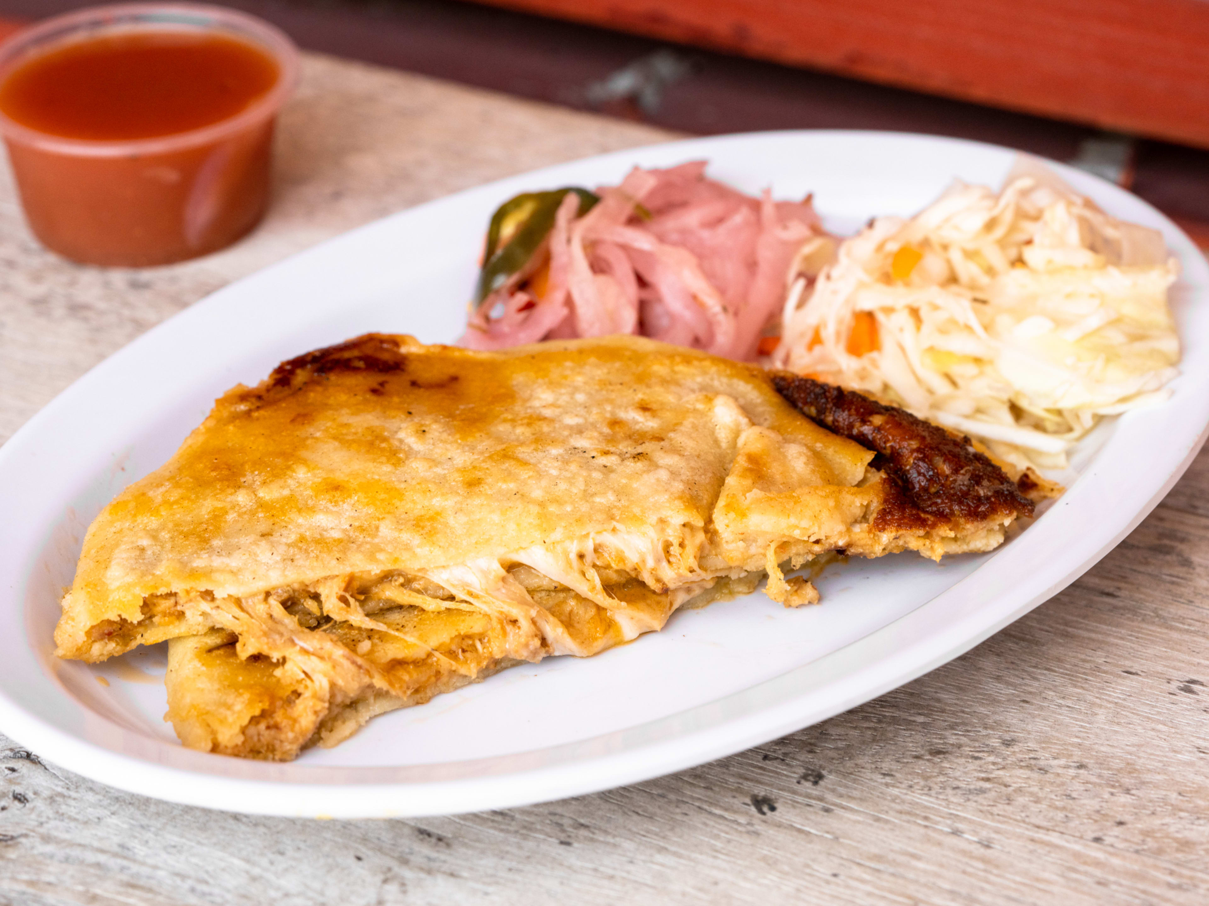 pupusa with cabbage and pickled vegetables.