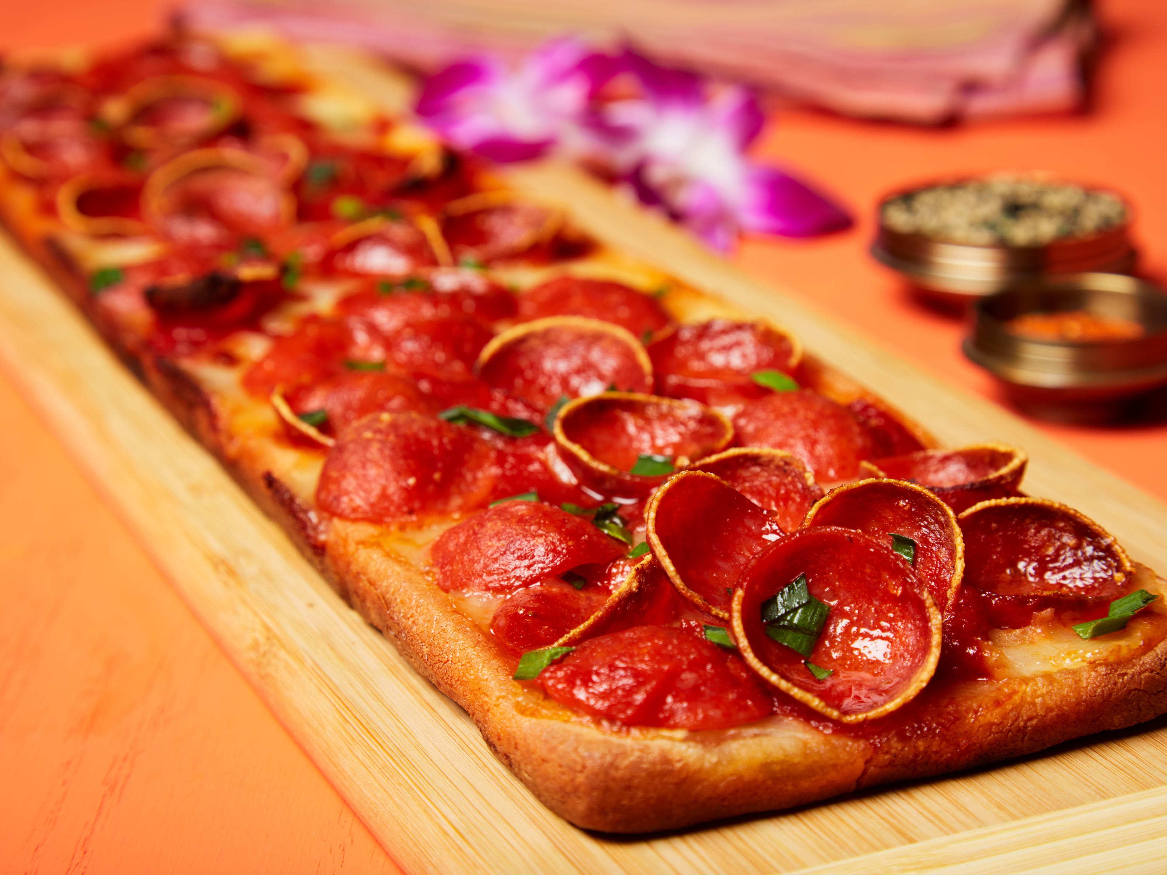 A rectangular mochi pizza with pepperoni.