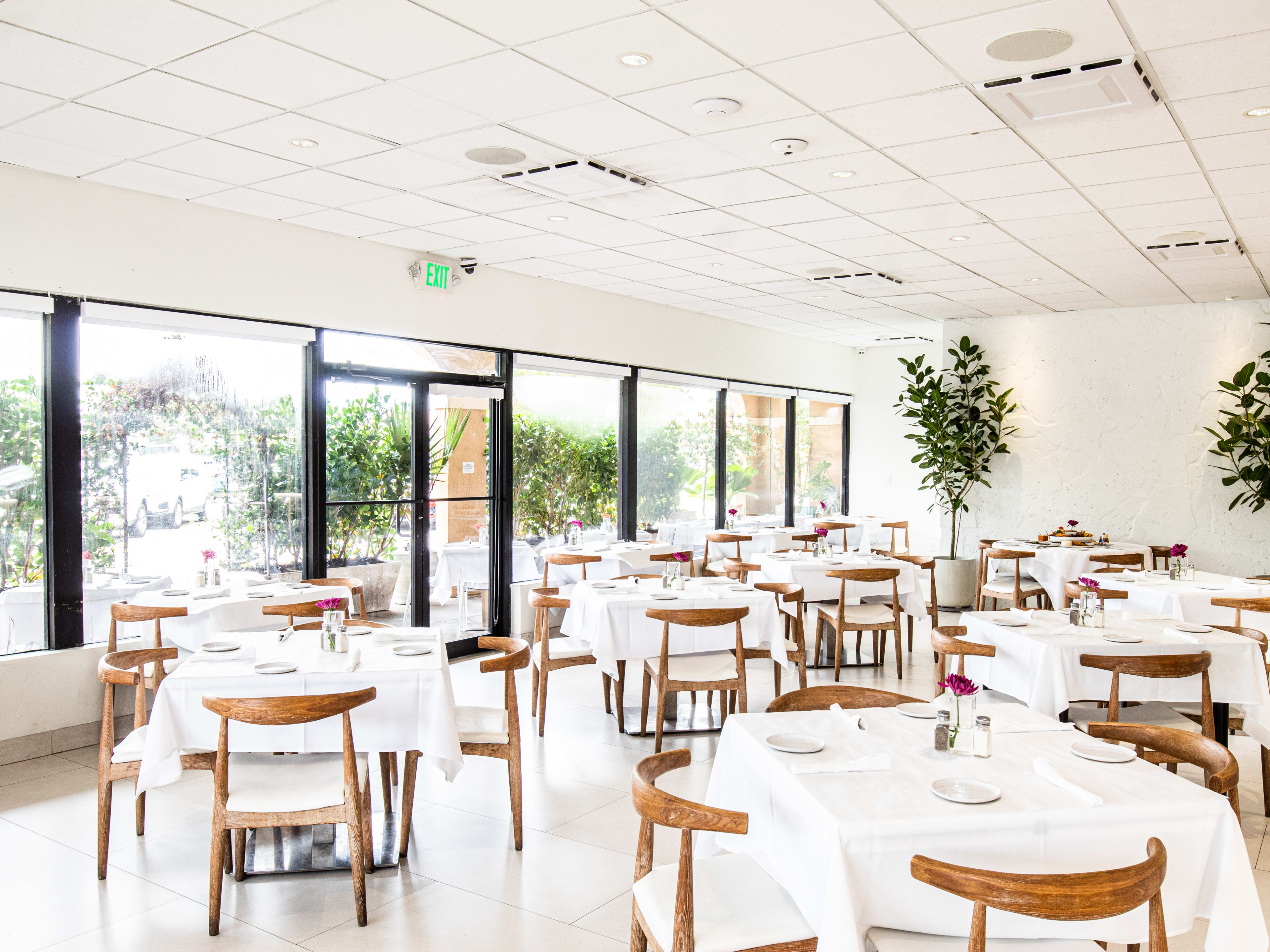 Madroño's dining room with white tablecloths and large windows.