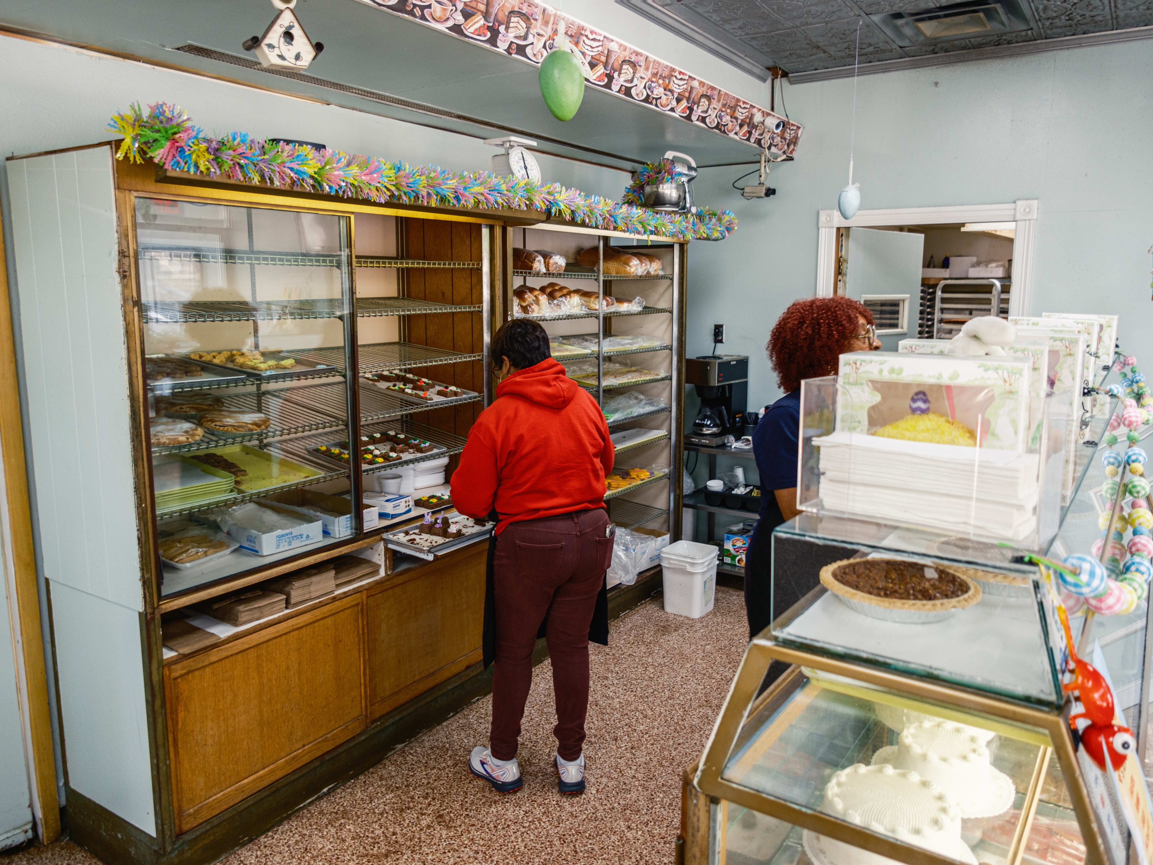 A person picks out pastries at Moeller’s Bakery.