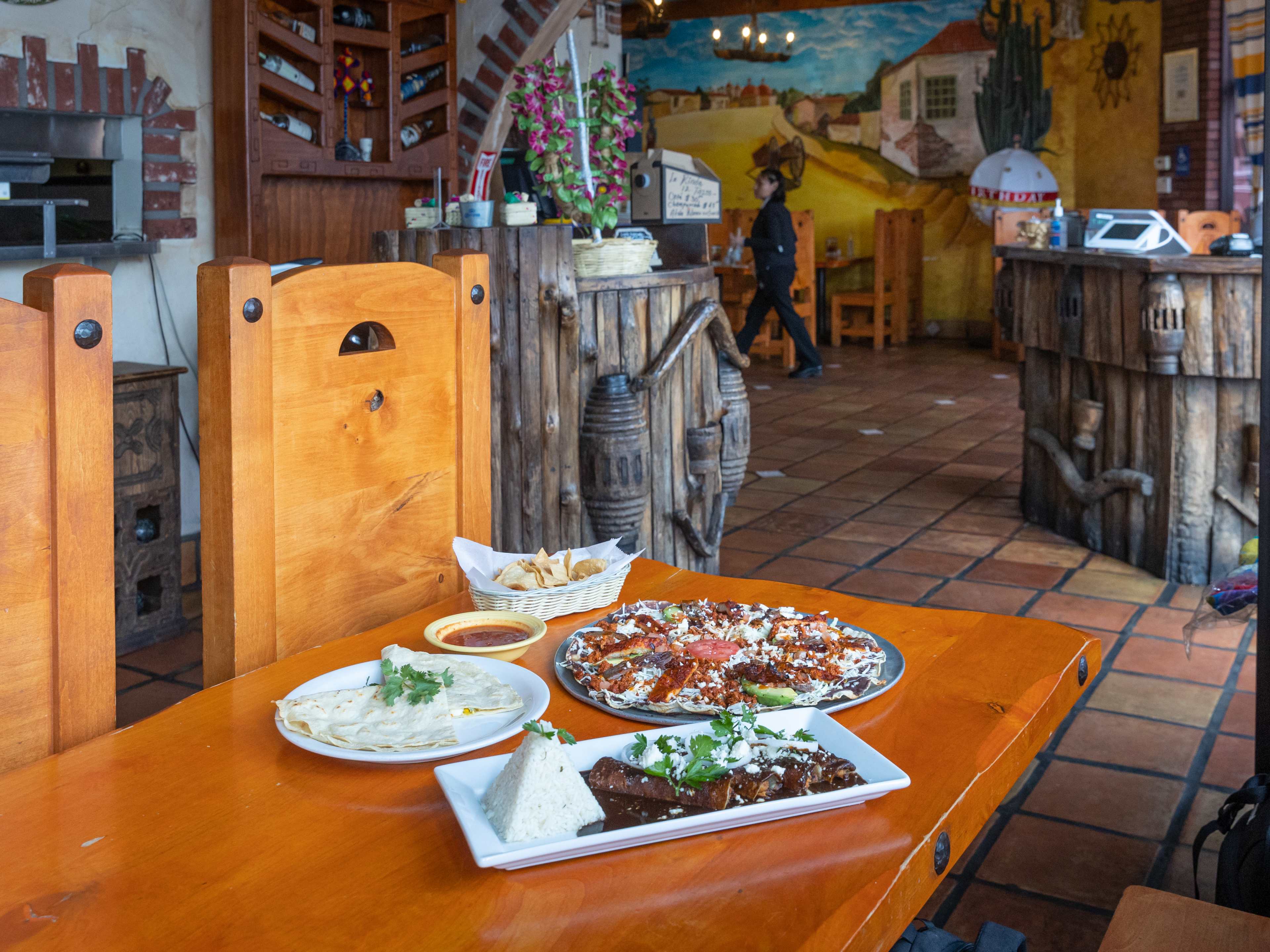 A spread of dishes on a wooden table at Monte Alban.