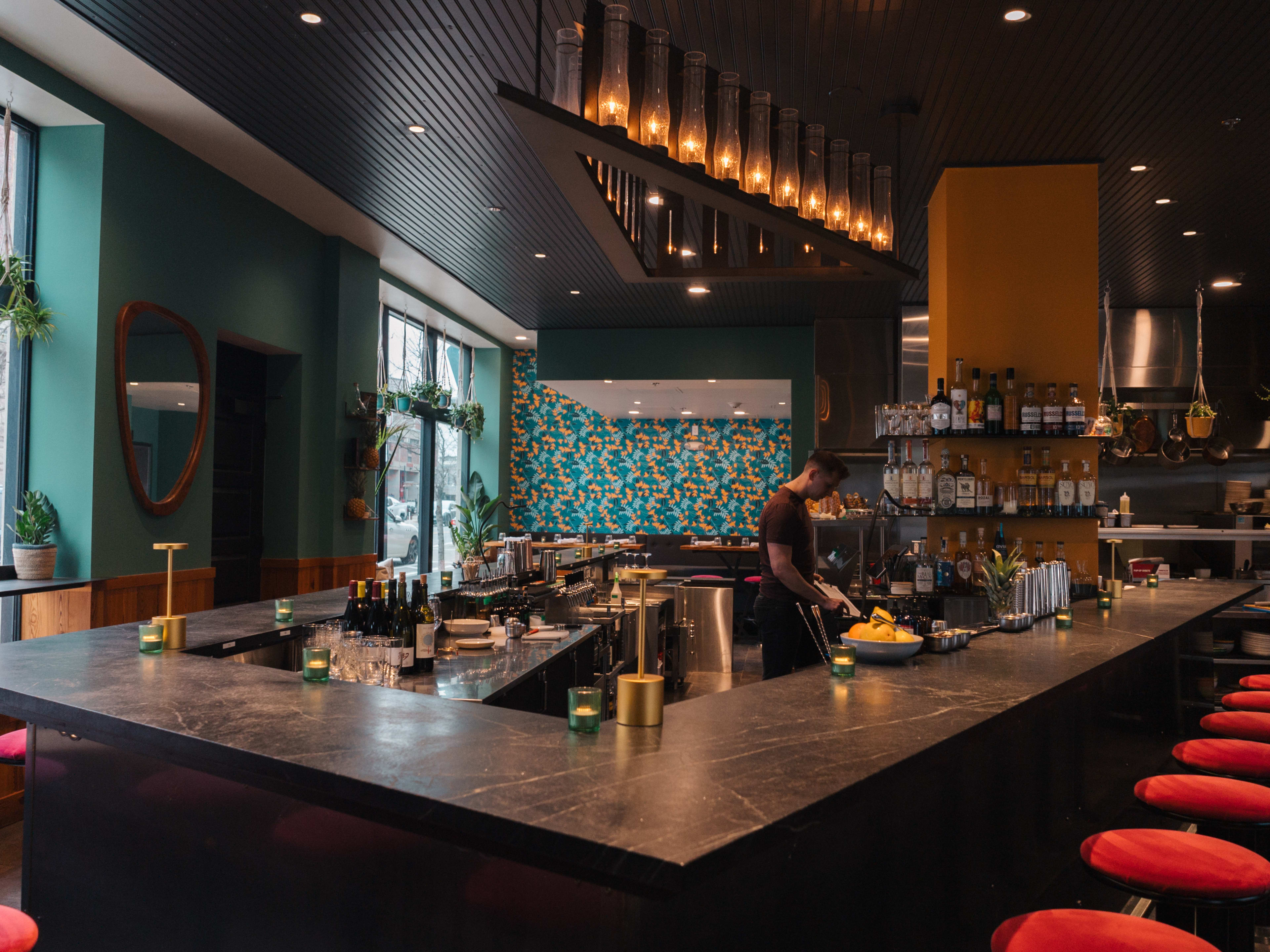 U-shaped bar space with red stools at Moon Bar