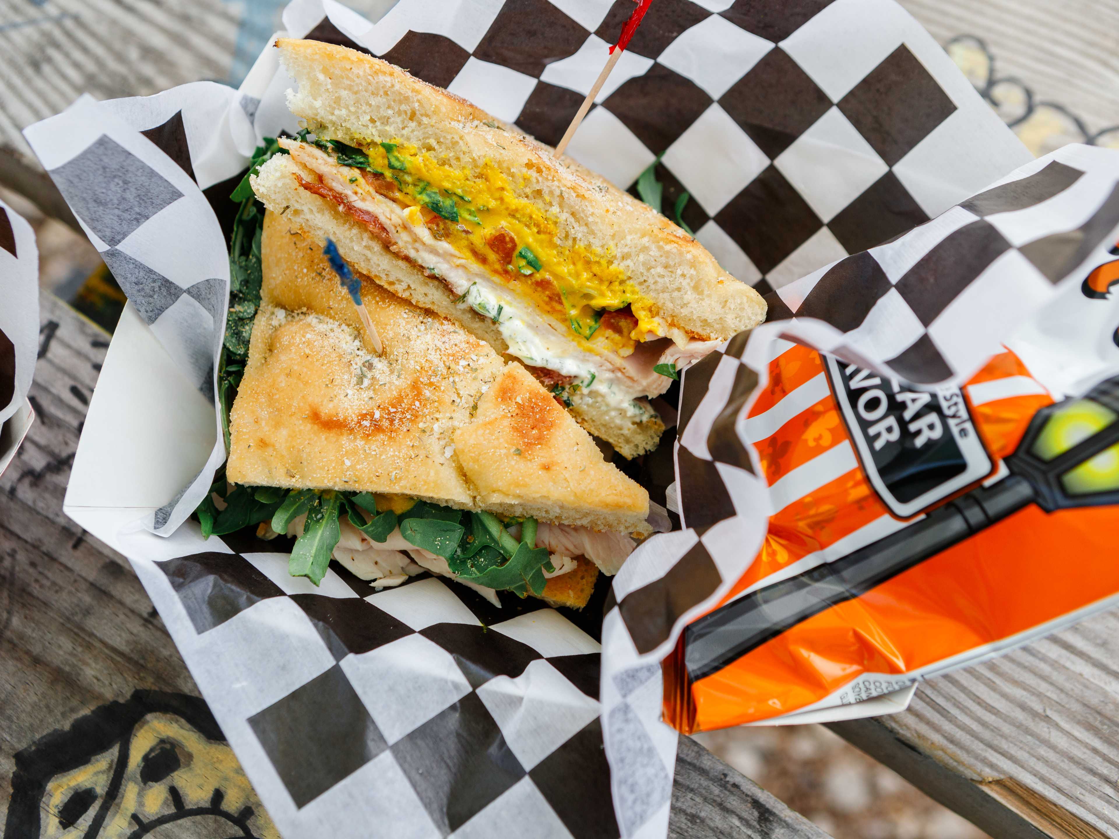 High Jive Turkey sandwich on foccacia bread in a basket lined with black and white checkered paper