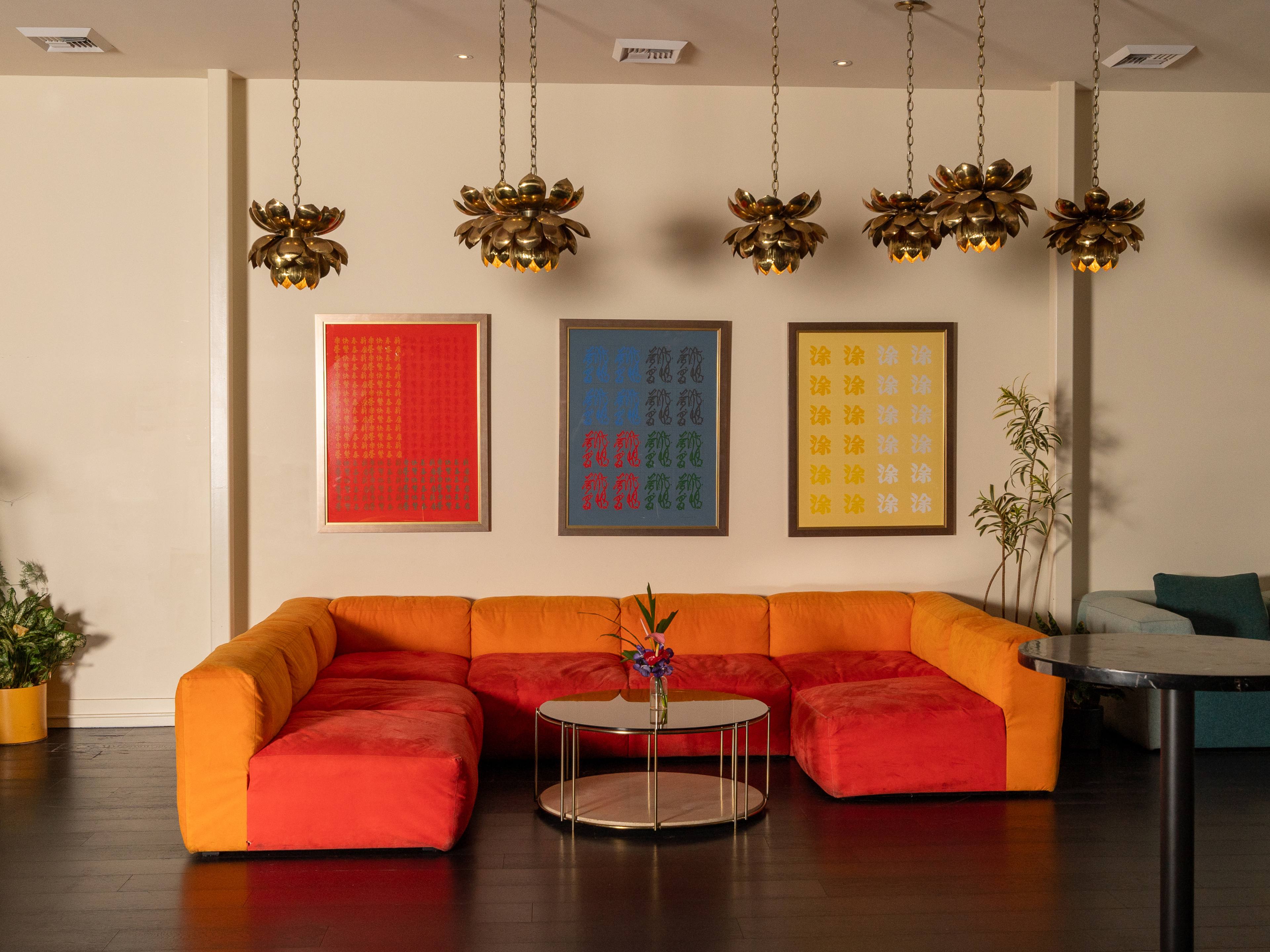 brightly colored modern sofa with table and colorful art on wall