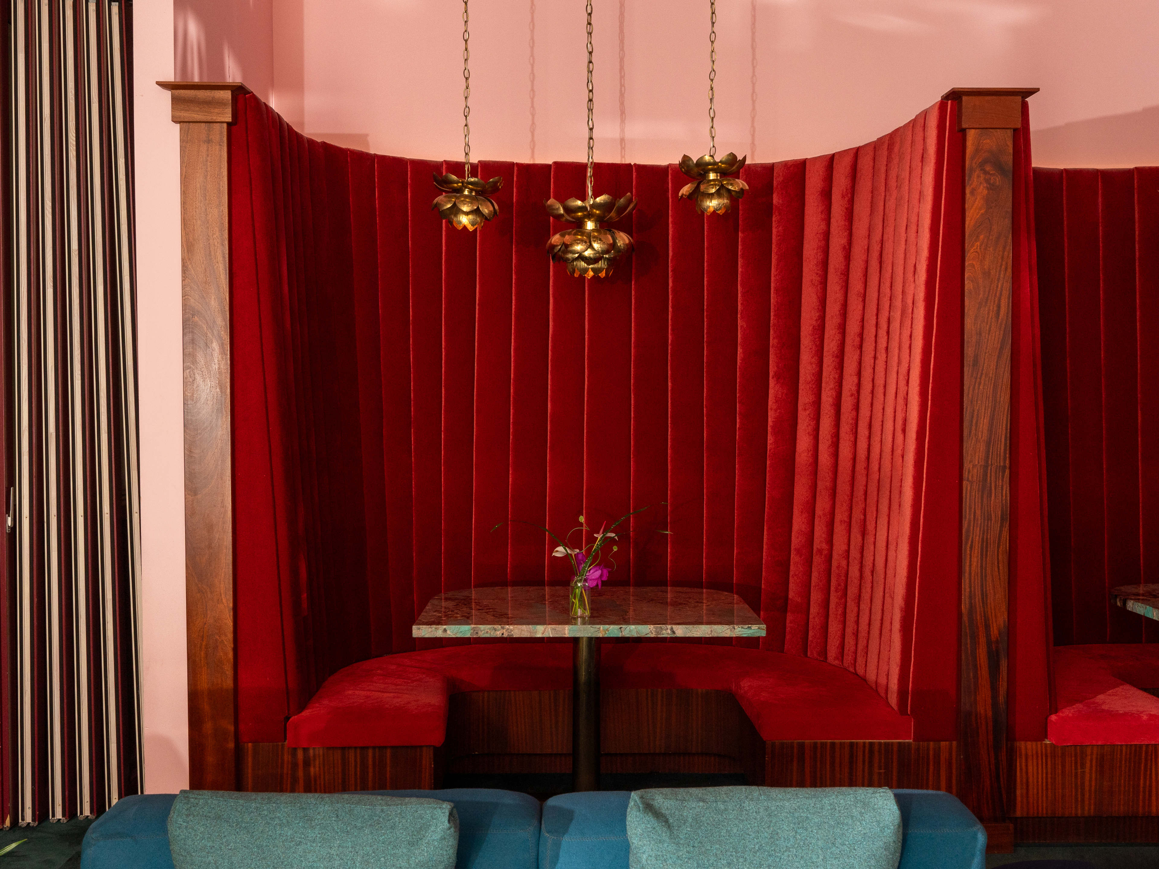 semicircle velvet booth with modern light fixtures and marble table