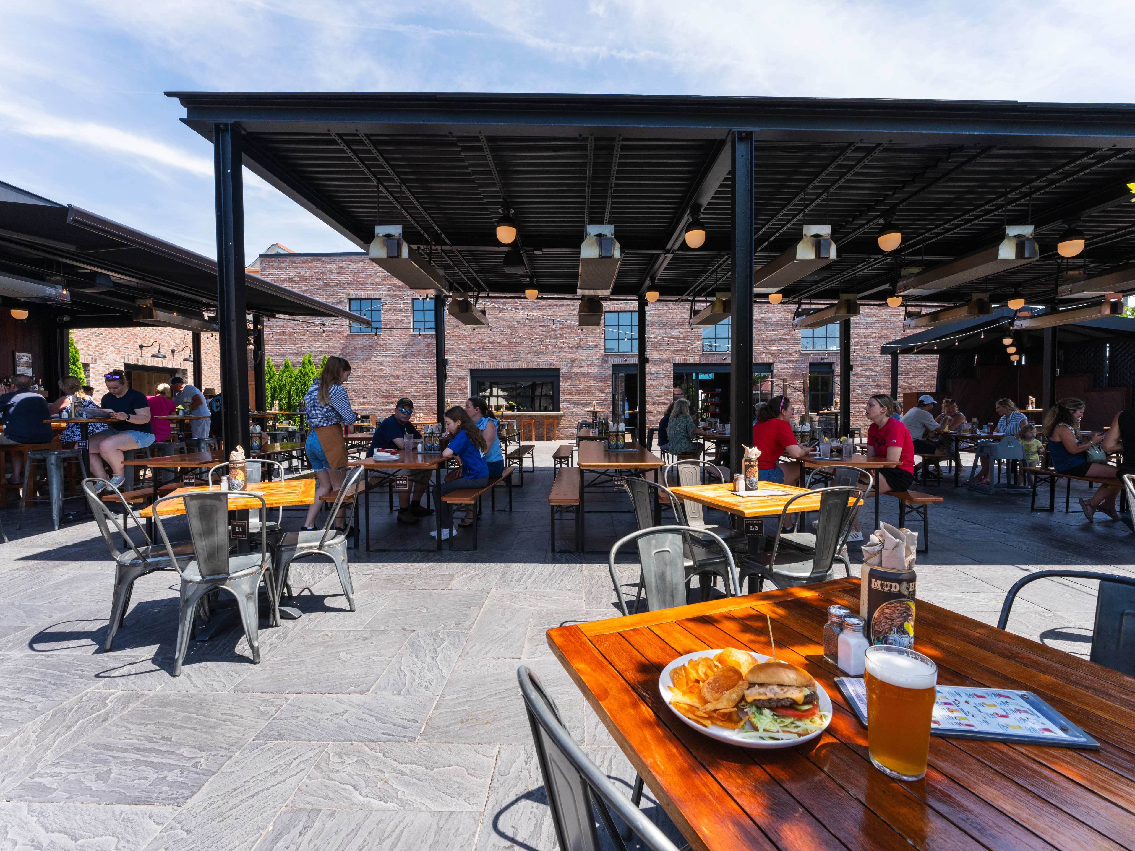 exterior courtyard of brewery with people sitting at tables