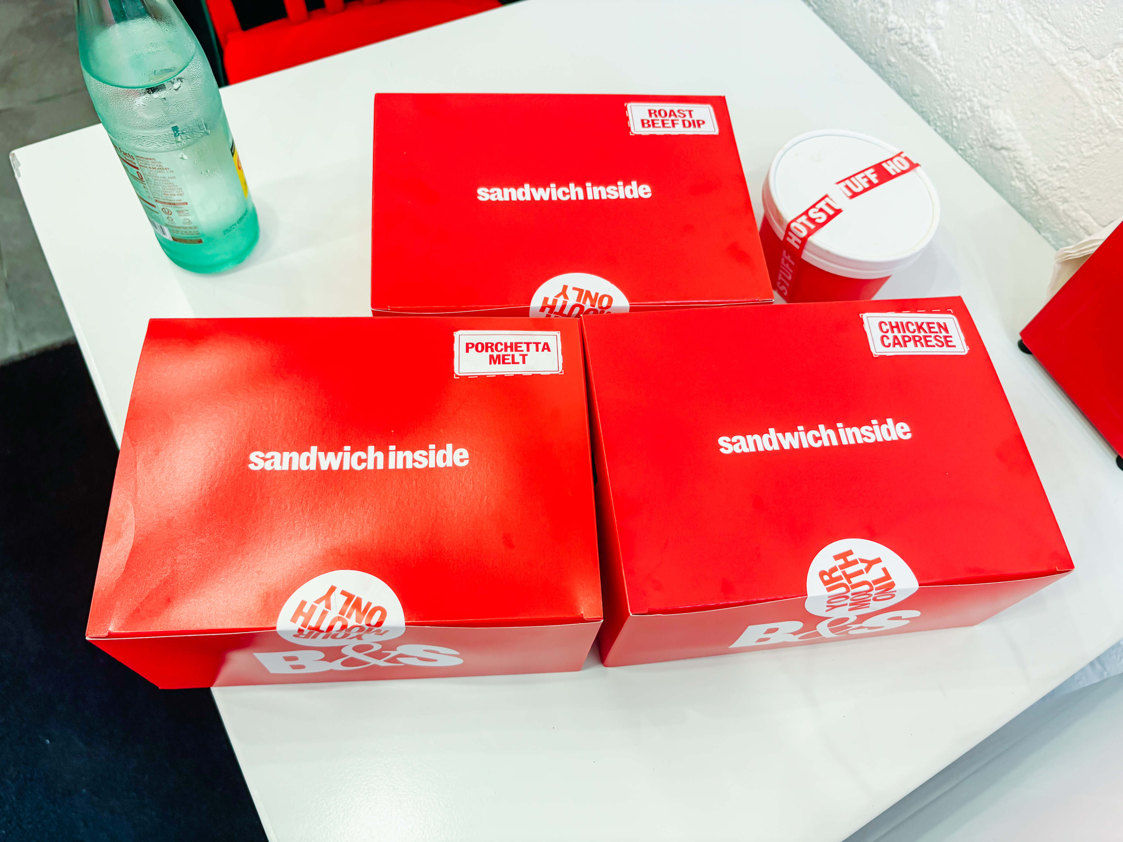 three sandwiches in boxes