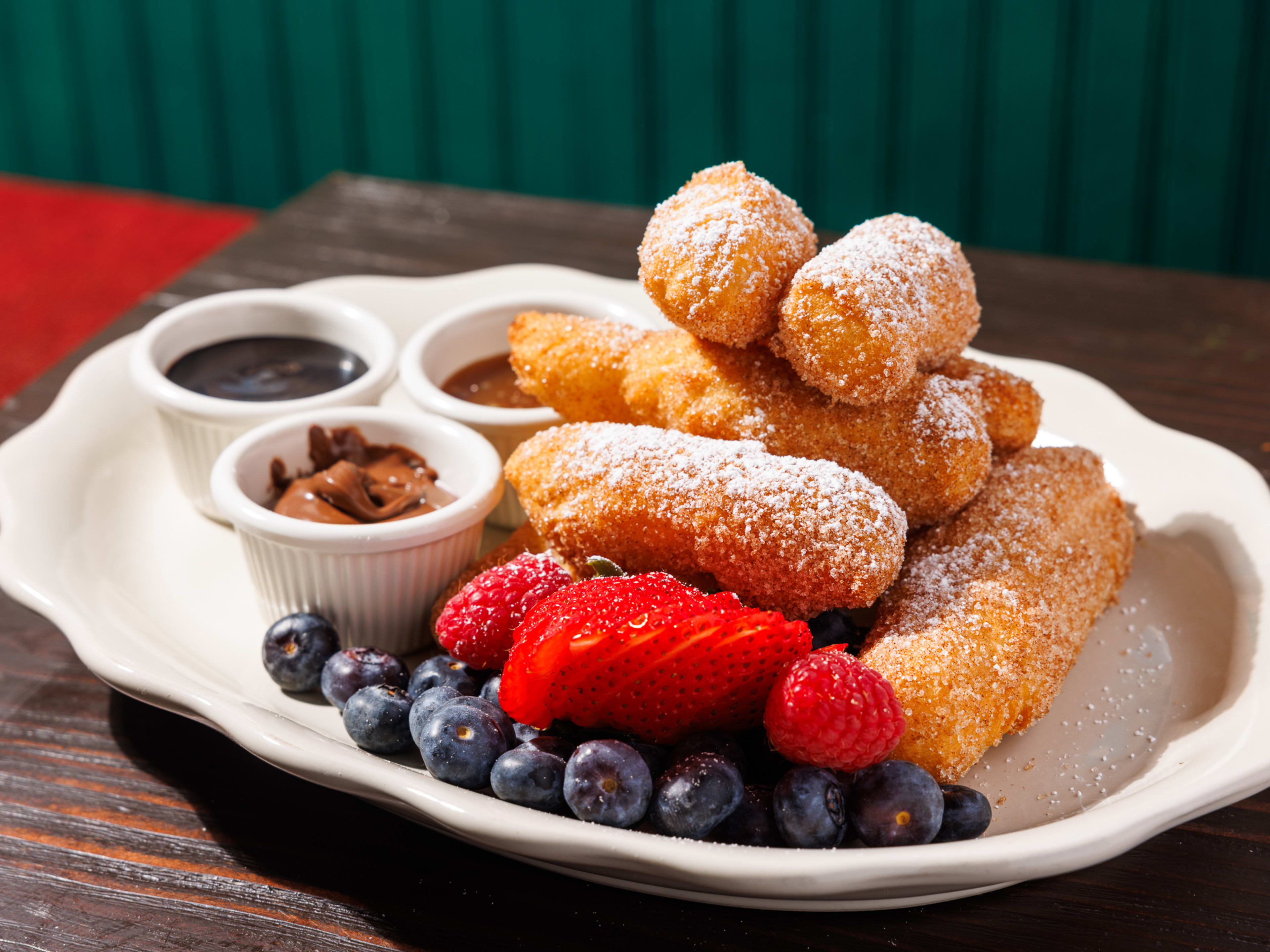 zeppole with chocolate dipping sauce and berries