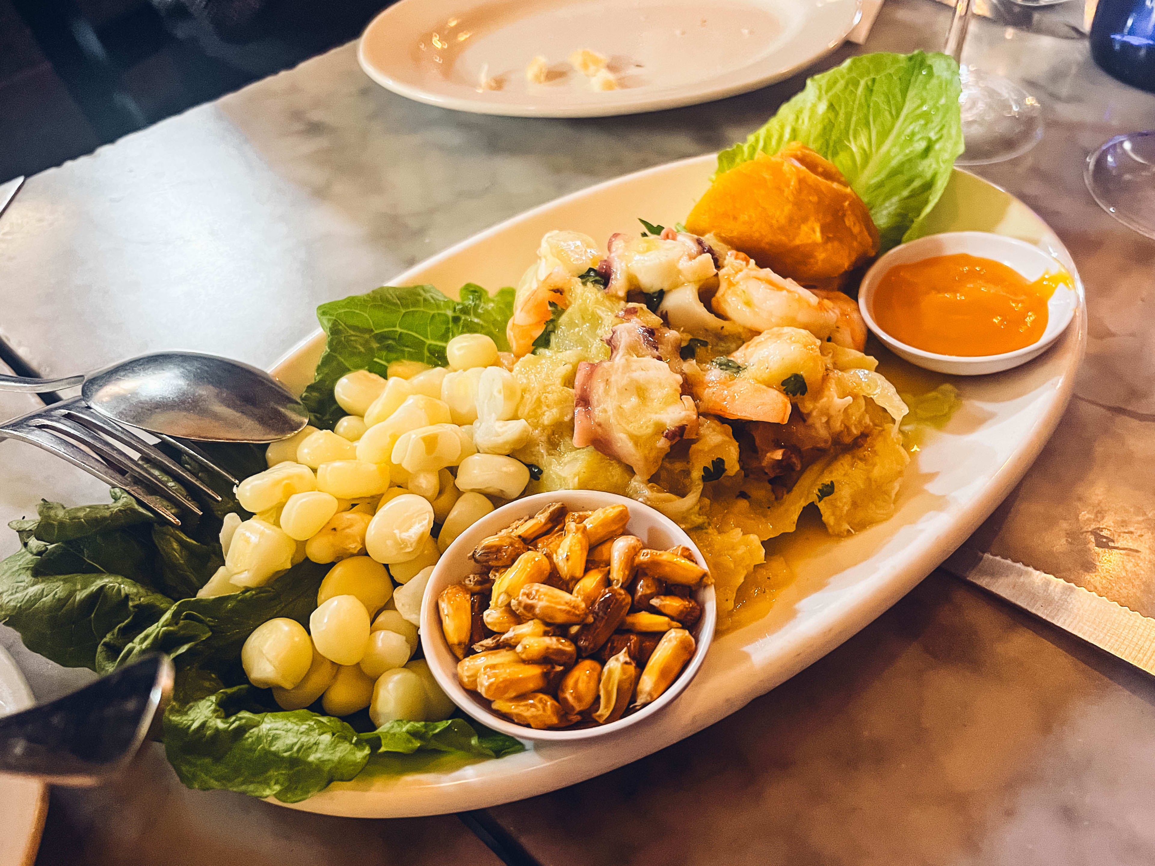 Ceviche from Enoteca Maria served on a white plate.